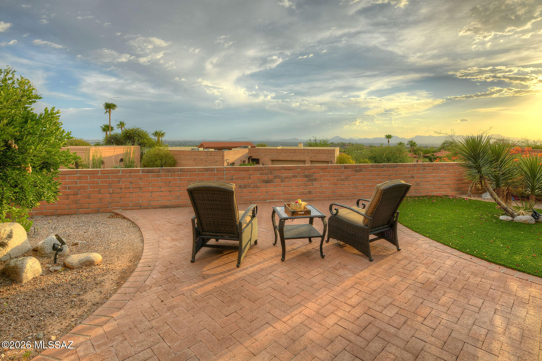 DON'T MISS OUT on this 2BD, 2BA townhome in the Foothills! Experience luxury living w/fabulous kitchen remodeled and featuring high end stainless appliances, white shaker style cabinets, quartz countertops, custom tiled backsplash, and designed to be bright and open with lots of natural light! Kitchen opens to expansive great room featuring high ceilings and a gas fireplace! Next to the kitchen is a room that could be a large formal dining room or separate den! The professionally landscaped backyard is low maintenance w/beautiful pavers, artificial grass & drought tolerant plants that thrive in Tucson climate! The patio offers amazing views day & night!