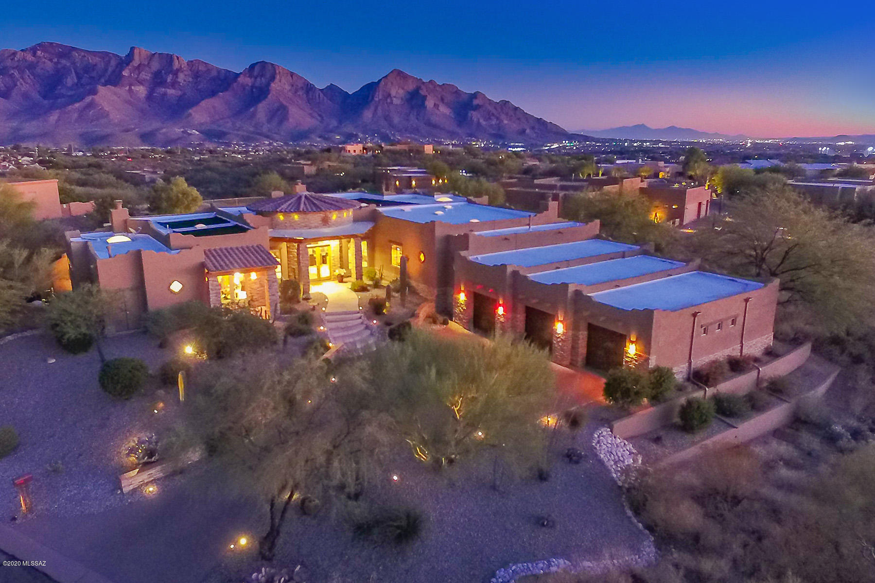 Spectacular 4BD/4.5BA (4,482 sq ft) custom estate boasts fine architectural details, luxury amenities plus captivating mountain and city light views. This raised, corner lot home on one acre offers formal & informal living, 4 fireplaces and en-suite baths. Custom details abound including a striking turreted entry, Travertine and wood flooring, stone wall facades plus wraparound view windows. Great room with media wall flows to a gourmet kitchen with dining nook. Private Master wing hosts a 2-way fireplace, jetted tub, walk-in shower and adjacent bedroom currently used as an office. Guest suite offers a fireplace and private patio. Huge 3 car garage with sauna room. Magnificent outdoor setting boasts a solar heated pool & spa, firepit surround, fountains, lush landscaping and forever views.
