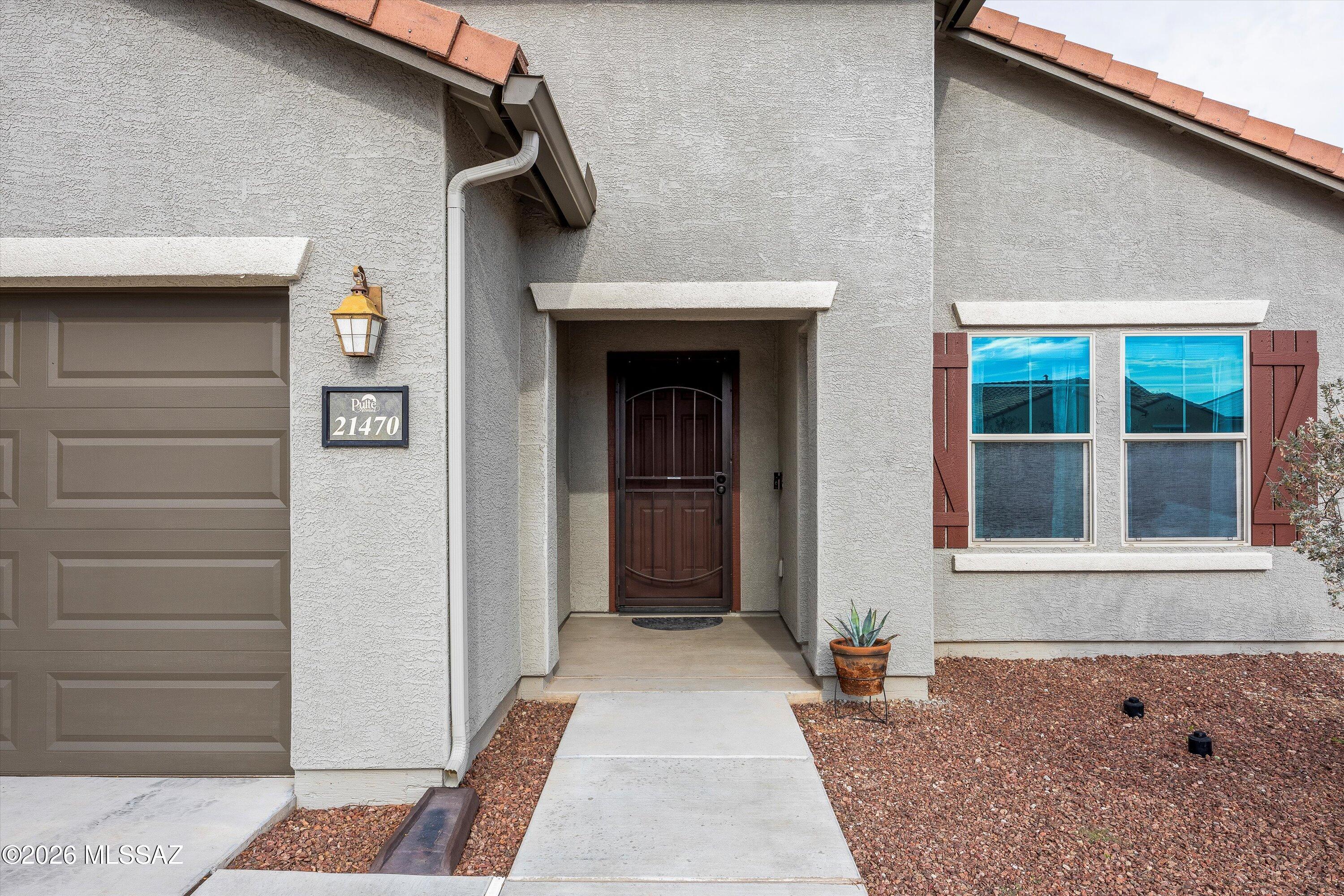 Freshly painted 4-bedroom home with a den/office in Red Rock Village, where thoughtful design meets a truly connected community. The open-concept floor plan creates an easy flow for everyday living and entertaining, complemented by tile flooring, fresh two tone paint, dual-pane windows, and ceiling fans throughout. The kitchen is both functional and welcoming, featuring recessed lighting, a pantry, generous cabinetry with crown molding, stainless steel appliances, and a prep island with breakfast bar seating. The spacious primary suite offers plush carpeting, a private bath with dual sinks, and a walk-in closet, while the flexible den provides the perfect space for a home office, exercise room, or quiet retreat. Beyond the home itself, the setting is what truly sets this property apart. The Seller describes the street as quiet, friendly, and exceptionally supportive, with neighbors who genuinely look out for one another. It's a place well-suited for those seeking peace and privacy while still enjoying a strong sense of belonging. The surrounding community is highly engaged, hosting events throughout the year and staying connected through several neighborhood Facebook groups. A local church that meets at the nearby school and plays an active role in the neighborhood and operates a community food bank, reflecting the area's spirit of involvement and care.
Conveniently located approximately 15 minutes from several major Marana developments, residents enjoy easy access to the newly opened Marana Aquatic & Recreation Center, a growing hub for fitness and community activities. Downtown Marana is in the planning stages of a walkable mixed-use district with future dining, shopping, and entertainment, while additional retail and dining destinations are underway near the Municipal Complex and in the Gladden Farms area. Together, these enhancements add long-term appeal while allowing this home to remain a peaceful retreat within a welcoming and established neighborhood.