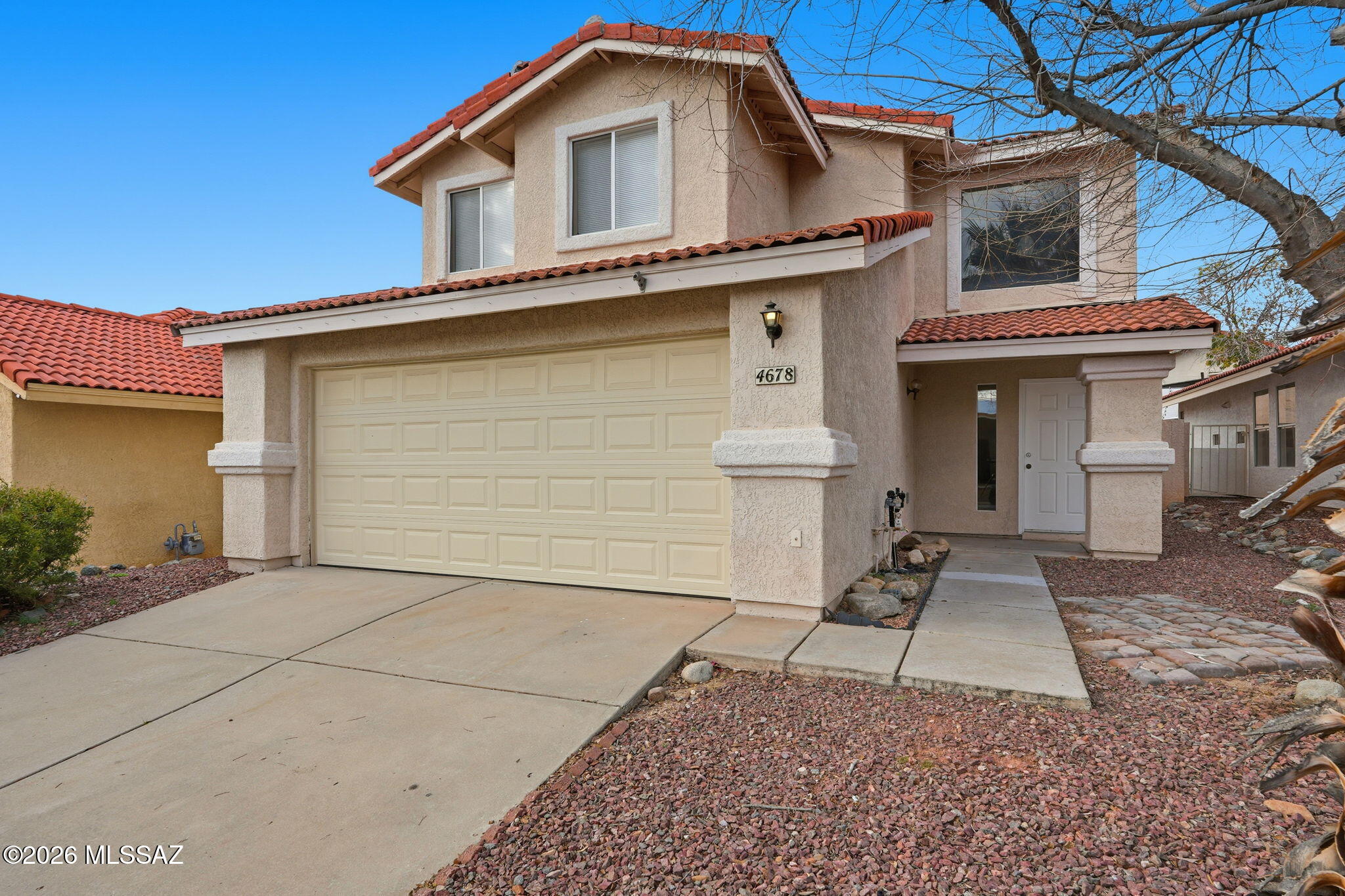 Spacious and inviting home located in the sought-after Northwest Country Highlands community. The thoughtfully designed floor plan features expansive living spaces, including a dramatic main living area with high ceilings, a separate dining area, and a comfortable family room off the kitchen. The kitchen is well appointed with light cabinetry, ample counter space, a pantry wall, breakfast bar, and a charming breakfast nook with bay window. The primary suite offers mountain views, two closets including a walk-in, dual vanities, and a tiled shower. Additional highlights include a dedicated laundry room and attached garage. Enjoy a generous backyard with a north-facing covered patio and a stucco masonry wall, ideal for relaxing or entertaining.