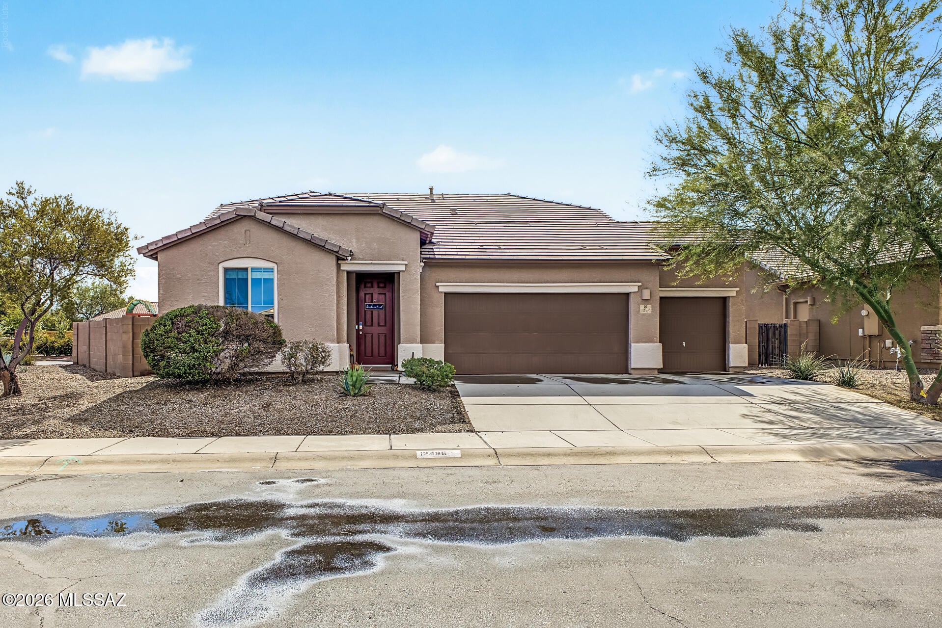 ou'll love this beautiful home in Gladden Farms! Sitting on a corner lot, it offers 3 beds + den, 2 baths, a 3-car garage, OWNED solar & low-care landscaping. The inviting interior showcases tons of natural light, a designer palette & carpet/tile flooring throughout. The kitchen boasts SS appliances, granite counters, recessed & pendant lighting, a pantry & ample wood cabinets. Its 2-tier peninsula overlooks the welcoming living space with surround sound, creating a great room effect! The formal dining room is adjacent to the kitchen. The versatile den can be an office, hobby room, or extra bedroom. The main bedroom ensuite has dual sinks, a separate tub/shower & walk-in closet. Relax or BBQ in the large backyard with a covered patio & artificial turf. Make this your dream home today! Check out the large backyard with a covered patio & artificial turf, where you can relax or enjoy BBQ! Make this your