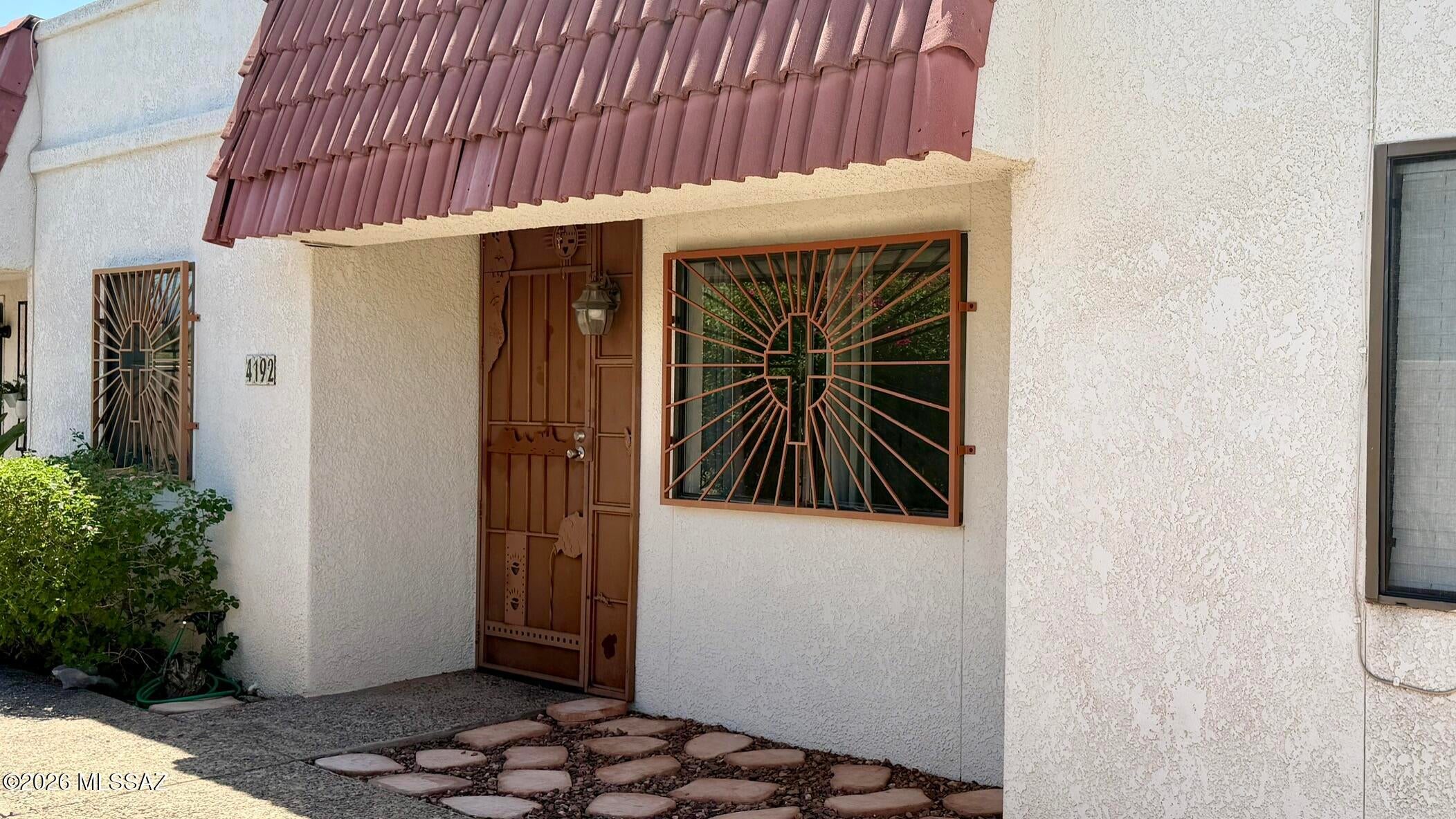 Centrally located 918 sq. ft. 2 bed/1 bath Townhouse. Skylights bring in nice natural light. New water installed 2025. Wrought iron security. In-unit laundry area with washer and dryer. Back patio. Designated covered parking space and storage room. Close to amenities. Make this your home today!
