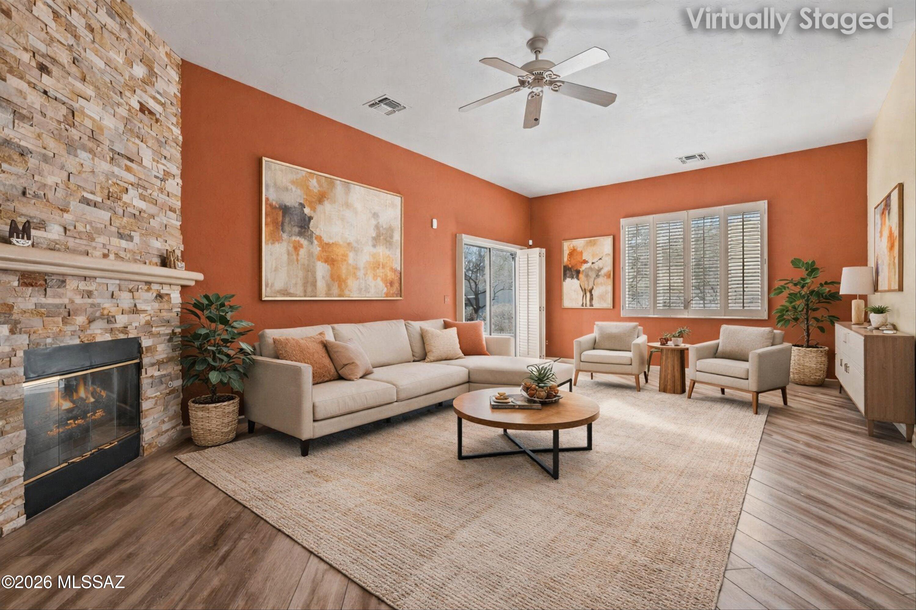 Set on a premium corner lot within the gated Carmel Pointe community, this fully upgraded 2-bedroom, 2-bath townhome stands apart with quality finishes, architectural detail, and a desirable split-bedroom floor plan that offers privacy and flexibility. Vaulted ceilings and abundant natural light immediately create a polished, open feel throughout the home.
The main living area is both spacious and inviting, highlighted by wood-look flooring, plantation shutters, and a dramatic stone-accented gas fireplace that serves as a true focal point. The open layout flows effortlessly, making the space ideal for everyday living while still feeling refined and intentional.
The upgraded kitchen is a standout, featuring granite countertops, a stacked stone backsplash, white cabinetry, stainless steel appliances, recessed lighting, a pantry, and a generous center island with breakfast bar perfectly suited for entertaining or casual dining.
The primary suite is privately positioned and offers a comfortable retreat with a walk-in closet and an upgraded bath showcasing granite countertops, dual vanities, a soaking tub, and a beautifully finished walk-in shower with tile surround and glass enclosure. The guest bath is equally well finished with granite countertops and a tiled shower, continuing the home's cohesive, upgraded design.
Outdoor living is enjoyed from the covered patio and low-maintenance yard, offering a comfortable extension of the interior space with minimal upkeep.
This home is just a short walk to the Oro Valley Community & Recreation Center, providing convenient access to pickleball and tennis courts, a resort-style pool, a full fitness center, and nearby championship 18-hole golf courses. Shopping, dining, outdoor recreation, and the natural beauty of the Santa Catalina Mountains are all close by.