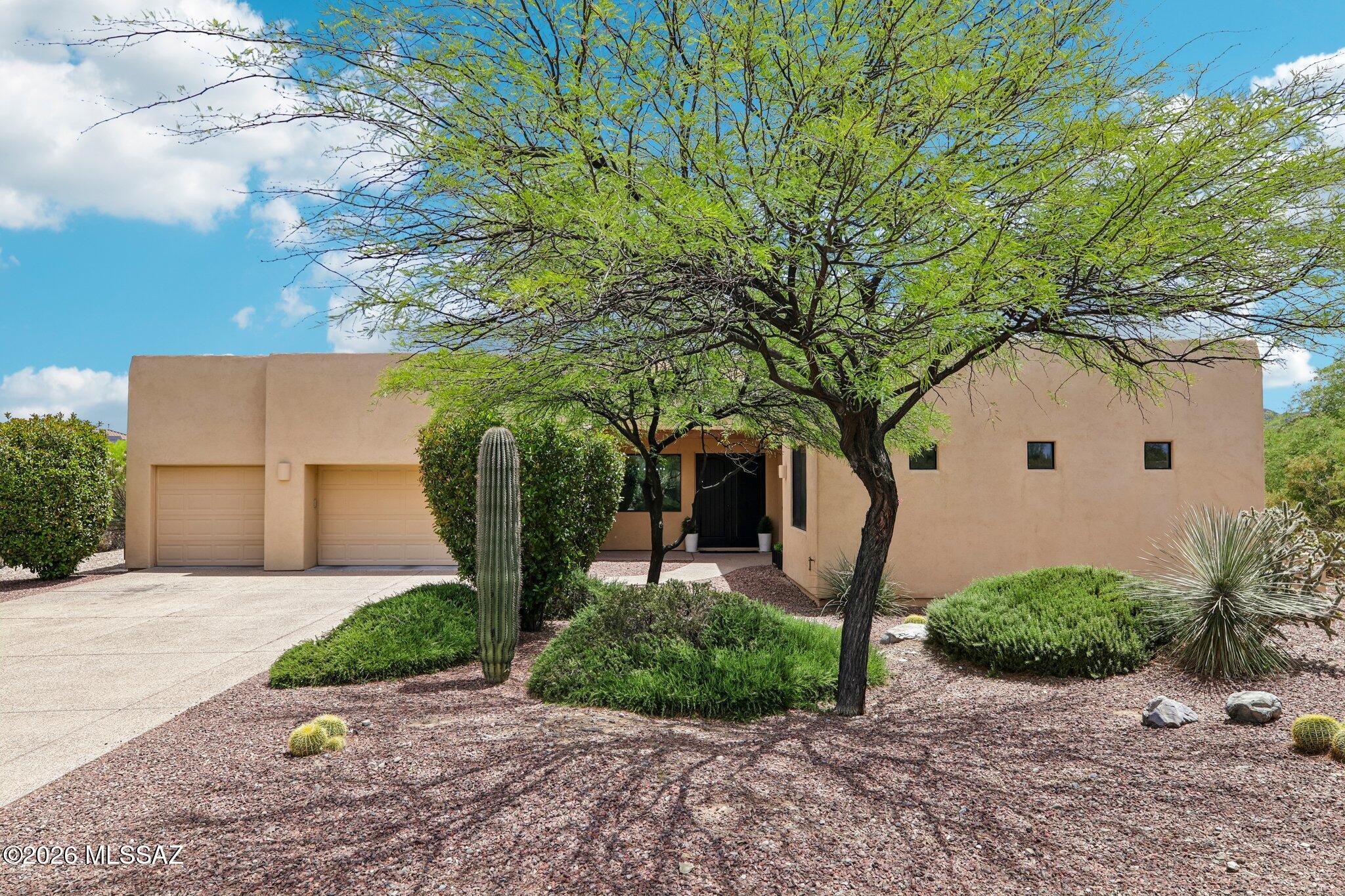 Enjoy clear, unobstructed views of Mount Fagan from both the main living area and the backyard. The home sits in a smaller, quiet neighborhood with low traffic, and the rear lot line backs to a natural wash, which adds separation and limits direct rear neighbors. Existing mature vegetation helps with privacy and reduces noise and dust. The yard is professionally landscaped with a mix of hardscape and plantings, set up for both everyday use and small gatherings. The placement of the house on the lot creates usable outdoor space while maintaining distance from adjacent homes. Located within a gated community, the property combines controlled access with a more private, tucked-away feel.