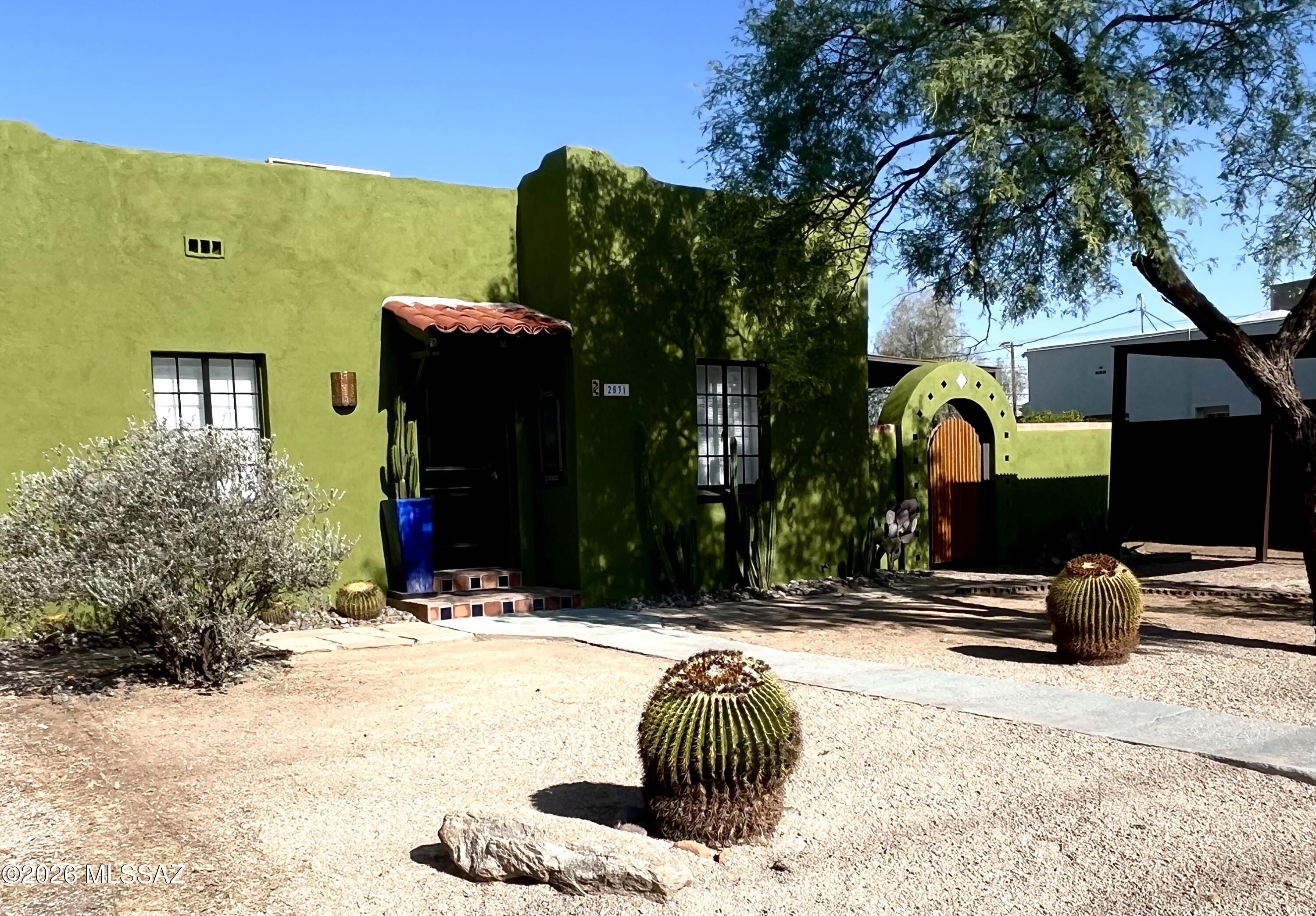 This spacious 2/1 home featuring beautiful vintage hardwood floors paired with authentic Mexican Saltillo tile, offers a perfect blend of classic character and warmth. Filled with natural light thanks to abundant windows throughout, thoughtfully renovated with designer updates including newer tile, fresh paint, modern lighting, and stylish plumbing fixtures. The inviting kitchen boasts a breakfast bar and stunning details that add a whimsical, vintage touch. Just off the kitchen is a convenient laundry room equipped with upgraded stackable washer and dryer that are included.