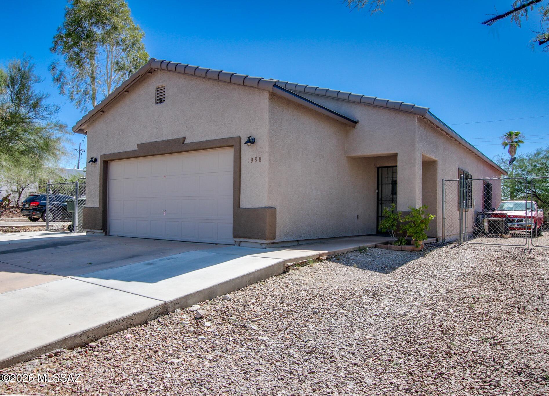 Welcome home to this 3-bedroom, 2-bath home featuring an open floor plan, tile flooring throughout, and leased solar for added energy efficiency. Roof replaced in 2025. The spacious kitchen offers abundant counter space, ample cabinetry, and breakfast bar, perfect for everyday living and entertaining. Tastefully updated bathroom. A versatile bonus room within the garage provides the ideal space for a home office, gym, or hobby room and can easily be converted back to full garage space if desired. Enjoy the large backyard with plenty of room to relax, garden, or entertain. Conveniently located near downtown with easy freeway access, this home offers comfort, flexibility, and an excellent location. No HOA! Seller is willing to payoff Solar Balance at COE with an acceptable offer.
