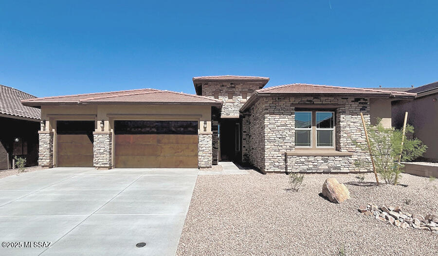 The ranch-style Holbrook plan offers a formal dining room connected to the gourmet kitchen via a butler's pantry. A large quartz kitchen island overlooks the nook and great room, with views of the covered patio. The primary suite includes two walk-in closets and a private bath. A fourth bedroom with an adjacent full bath and two bedrooms with a Jack-and-Jill bath are included. Scheduled for completion in April 2025!