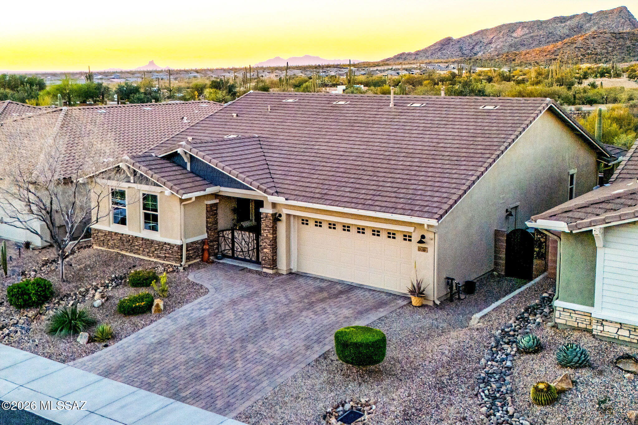 Single-story home near The Ritz-Carlton Dove Mountain with Tortolita Mountain views in the gated Dove Mountain community. Built in 2016, this home offers 3 bedrooms plus a den, 2 bathrooms, and approximately 2,113 sq ft with a 3-car tandem garage. The open layout features granite countertops, dark wood cabinetry, stainless steel appliances, gas cooktop, wall oven, large island, and walk-in pantry. Vaulted ceilings and a custom fireplace feature wall completed in 2023 highlight the living area. The primary suite includes a large walk-in closet and oversized walk-in shower. Backyard features a private pool with water feature, extended paver patio, and covered patio. Located near The Golf Club at Dove Mountain, hiking trails, and resort amenities.