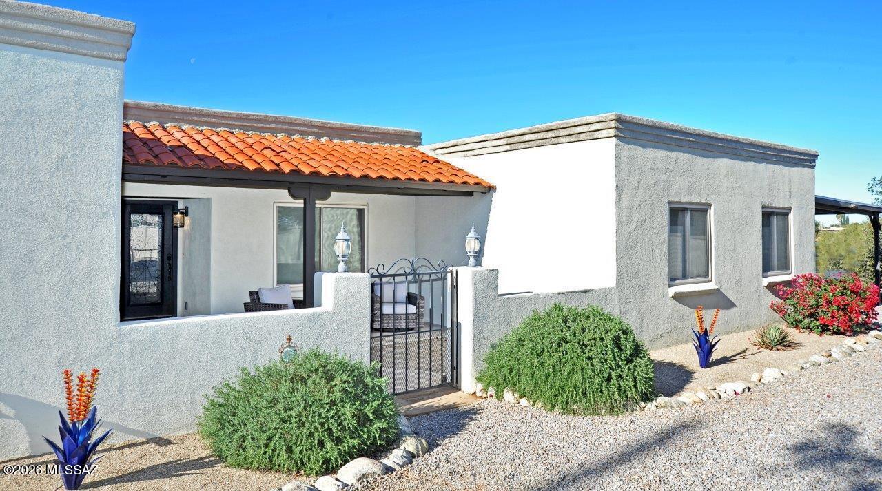SELLER'S ARE MOTIVATED!!  Tucked away behind a lengthy gated driveway on nearly an acre of walled property, this 4-bedroom, 3 bath home offers a quiet sanctuary w/unobstructed views & legendary Arizona sunsets. Dual Primary Suites - a rare & highly sought-after layout featuring two spacious primary bedrooms w/updated vanities, modern showers, & walk-in closets-ideal for multi-generational living - the open-concept kitchen features granite countertops.  The workshop is heated & cooled w/a utility sink, plus two additional storage units for all your gear & toys. Seller is offering a home protection plan.  Great opportunity!! Security Gate Code Required