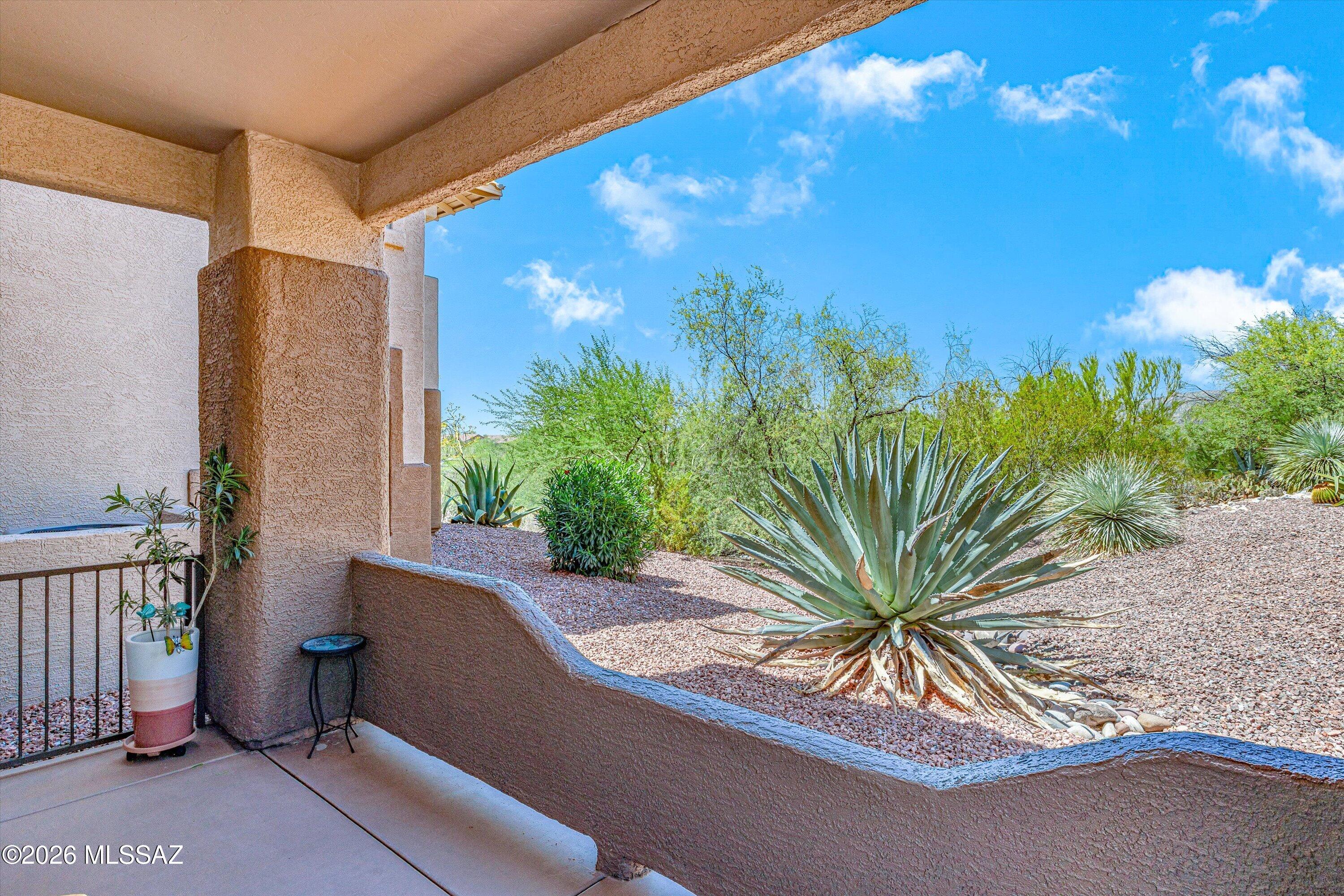 Fully furnished first floor 2 bedroom, 2 bath corner condo with a patio that backs to a desert oasis common area. Open kitchen with 3 stool breakfast bar looks into light, bright living area with handy built ins. Split bedrooms each have generous closets. All tile living areas with carpeted bedrooms.16 Seer AC new in 2025, 2019 water heater, Entire home had ducts sealed by Aeroseal in 2025, New toilets in 2026, HOA installed new roof in 2023/24. HOA covers water, sewer, trash, basic cable, streets, exterior building, roof, termite, common area landscaping, pool and clubhouse. 3 day rental minimum - Buyer to verify with HOA if using as an investment.