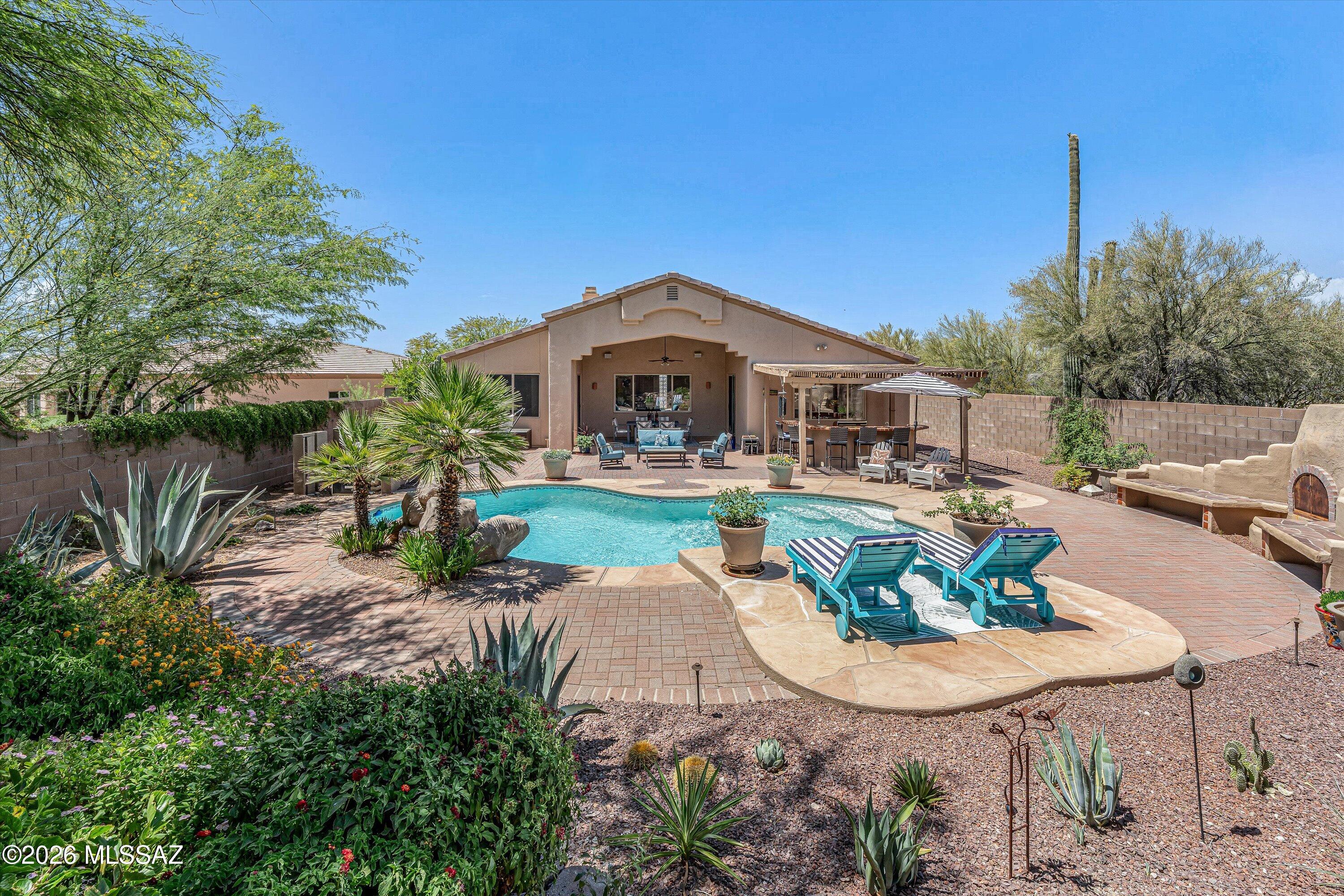 Tucked away on a quiet cul-de-sac, this beautifully upgraded single-family home offers the perfect blend of privacy, comfort, and effortless indoor-outdoor living. Designed with a desirable split floor plan and an open-flow layout, the home feels spacious, inviting, and ideal for both everyday living and entertaining. Enjoy seamless living with all ceramic tile flooring throughout and no interior steps, creating a clean, cohesive design with accessibility. The home currently features 2 bedrooms, with the secondary bedroom easily converted back into the original 3-bedroom configuration if desired. Step outside to your own private backyard retreat. The lush floral gardens are truly breathtaking - reminiscent of a botanical garden - surrounding a sparkling pool with brand-new pool equipment.