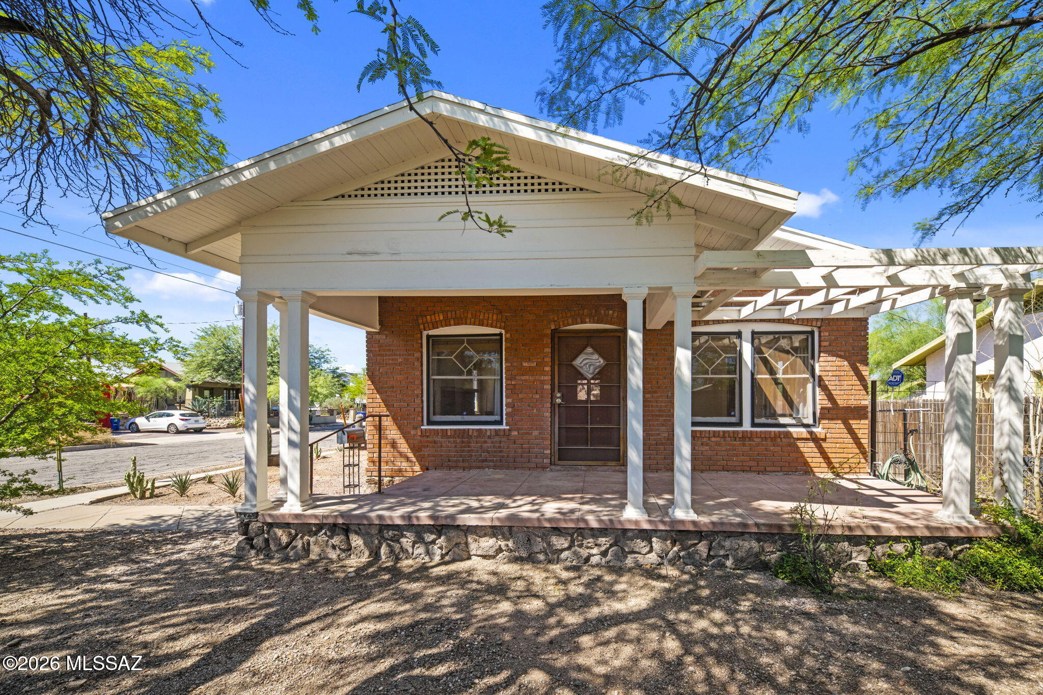 Classic 1920s red brick bungalow in the heart of Tucson's University area, just blocks from the UofA  campus and Banner - University Medical Center. Full of timeless character, this charming home features original hardwood floors, high ceilings, an updated kitchen and inviting living spaces filled with natural light. A spacious covered front porch and raised wall adds to the home's classic curb appeal and offers the perfect spot to enjoy Tucson mornings and evenings. An incredible location for those looking to be close to the U of A, Banner, Downtown Tucson, dining, shopping and more--all while enjoying the charm of a true historic Tucson bungalow.