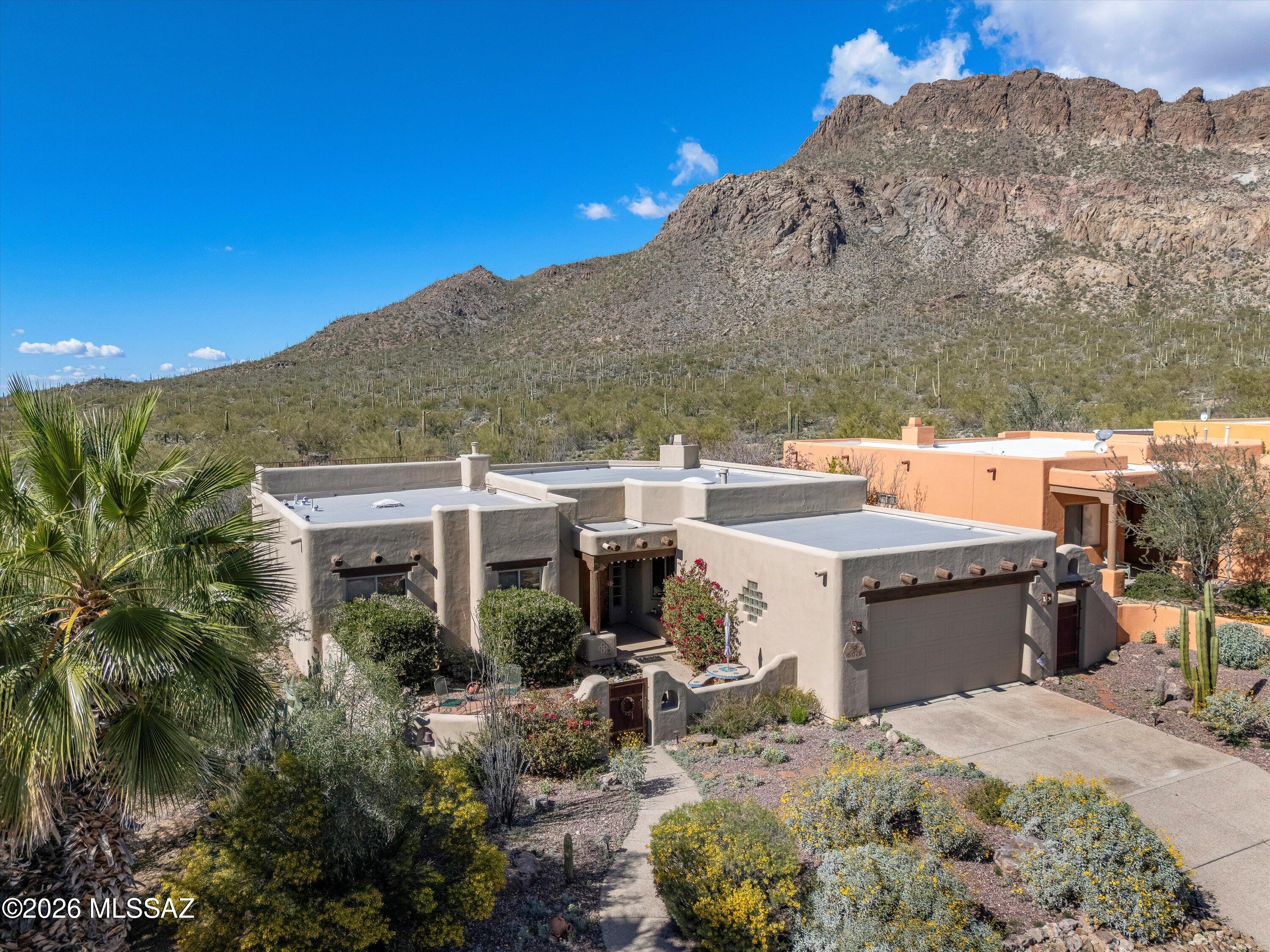 Wake up to breathtaking desert beauty in this stunning single-story retreat backing directly to Golden Gate Mountain. Perfectly positioned to capture panoramic views and Arizona sunsets, this home offers the ideal blend of comfort, privacy, and resort-style living.

Step inside to soaring high ceilings and an expansive open floor plan designed for effortless entertaining. Natural light pours through the living spaces, highlighting the seamless indoor-outdoor flow that makes this home truly special.

The spacious primary suite features a cozy fireplace--perfect for cool desert evenings--and provides a peaceful escape at the end of the day. One of the home's most impressive features is the private rooftop deck, where you can enjoy unobstructed mountain views and star-filled skies. Whether you're searching for the perfect winter getaway or a full-time desert sanctuary, this home delivers. Just a short drive to golf, a sparkling community pool, and tennis courts, you'll enjoy the best of Tucson living while coming home to unmatched tranquility and scenery.