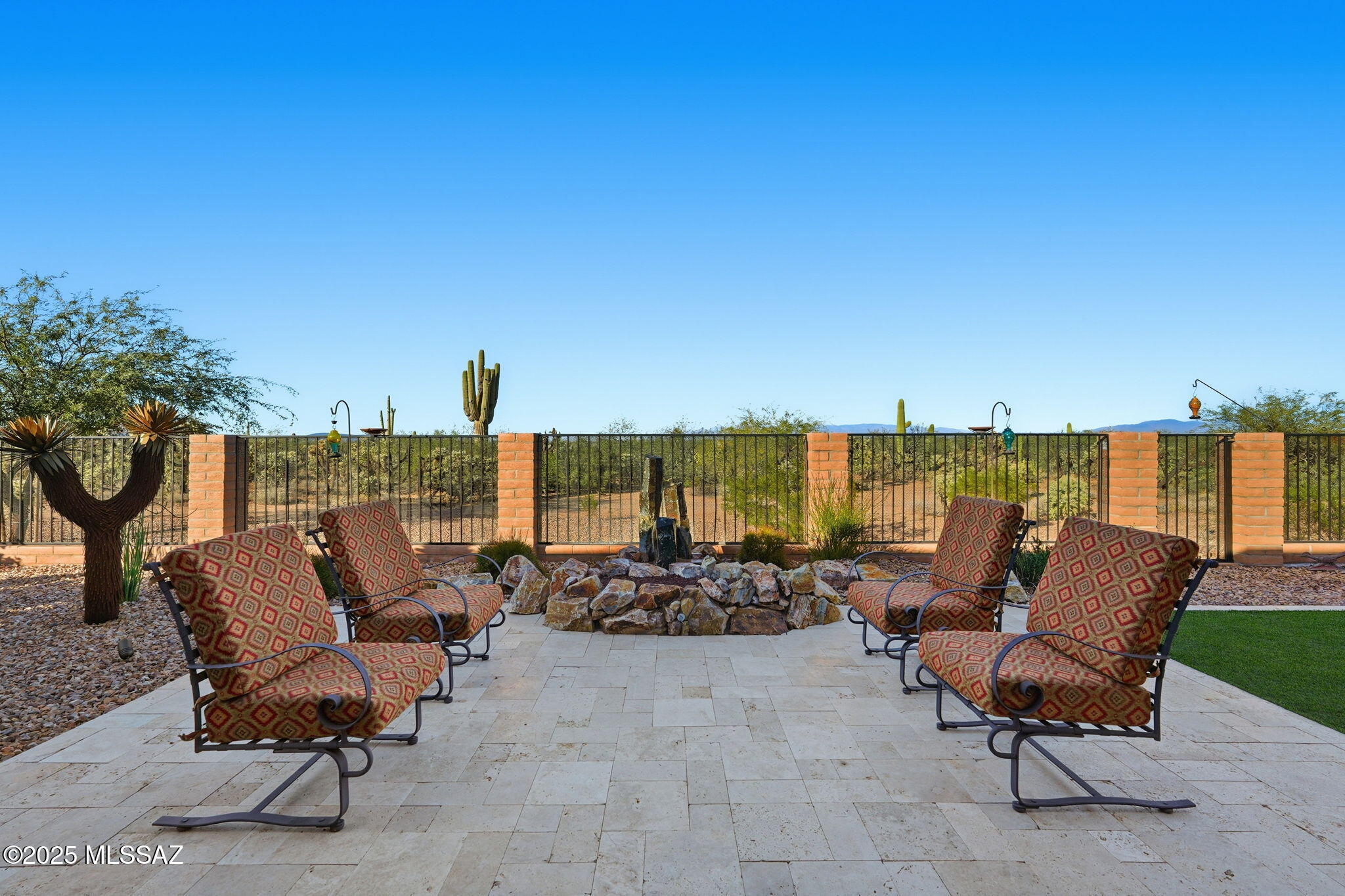 This magnificent Vienta floor plan is a true shining star of Quail Creek, offering breathtaking panoramic north-facing views and an exceptional level of quality throughout. From the moment you arrive, the home impresses with its striking curb appeal, enclosed front courtyard, and private casita with a tiled shower with glass door—perfect for guests, hobbies, or a quiet retreat.

Inside, thoughtful upgrades and architectural details abound. Coffered ceilings grace the foyer, primary suite, and den, while upgraded cabinetry, crown molding, 5.25-inch baseboards, plantation shutters, and high-end ceiling fans elevate every room. The expansive kitchen is a showstopper with an extra-large granite island, additional upper cabinetry, soft-close and roll-out shelves, RO water system, and a preimium Signature stainless appliance packageall flowing seamlessly to the outdoors through a dramatic stackable sliding glass door. The primary suite is extended by two feet and features a spa-like bath with a curbless roll-in shower, and custom California Closets system. The ensuite casita also includes built-in cabinetry, offering versatility and comfort.

The extended 3 car garage includes a four-foot extension, epoxy-coated floors, side-mount opener with windows, service door, mini-split, utility sink, Kinetico water system, and extra insulationideal for storage, projects, or temperature control. Additional features include a tankless water heater with recirculating pump, rain gutters, smart home automation with alarm system, automated door locks and thermostat, and a fully outfitted laundry room with cabinetry and sink. (Washer/Dryer do not convey)

Outdoors, enjoy travertine decking, electric roll-down patio shades, and discreet mesh fencing designed to keep desert wildlife at bayallowing you to relax and take in the beauty of the surrounding landscape.

All of this, paired with the world-class amenities of Quail Creek, makes this home an extraordinary opportunity to enjoy refined desert living at its finest.