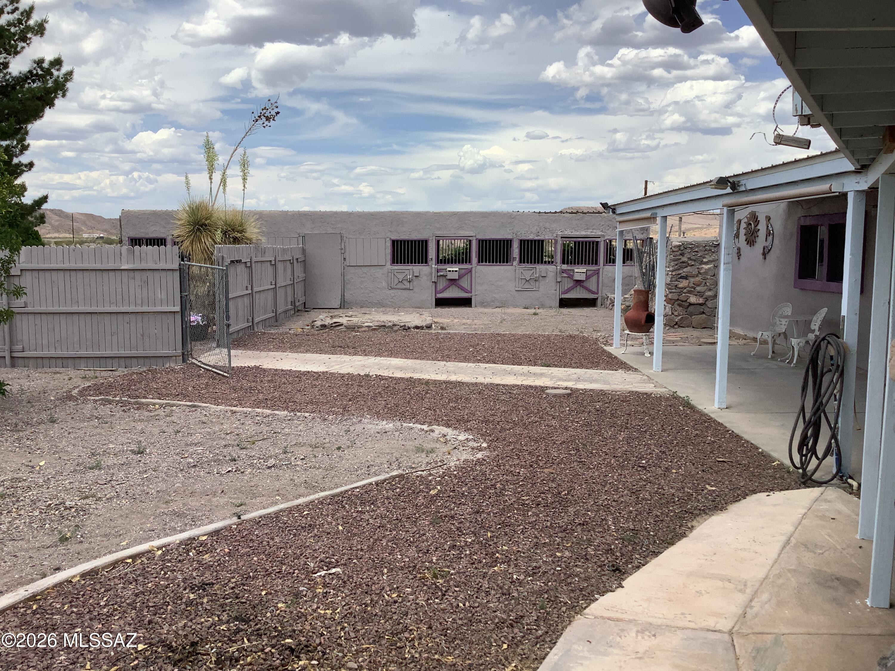 This unique 1-bd & 1-bath home sits high on a hillside with fantastic views, nice open floor plan. 1-car detached garage, covered patio, enclosed courtyard & horse stalls; along with a private well & driveway lined with mature trees. This would be a great private oasis or rental property.