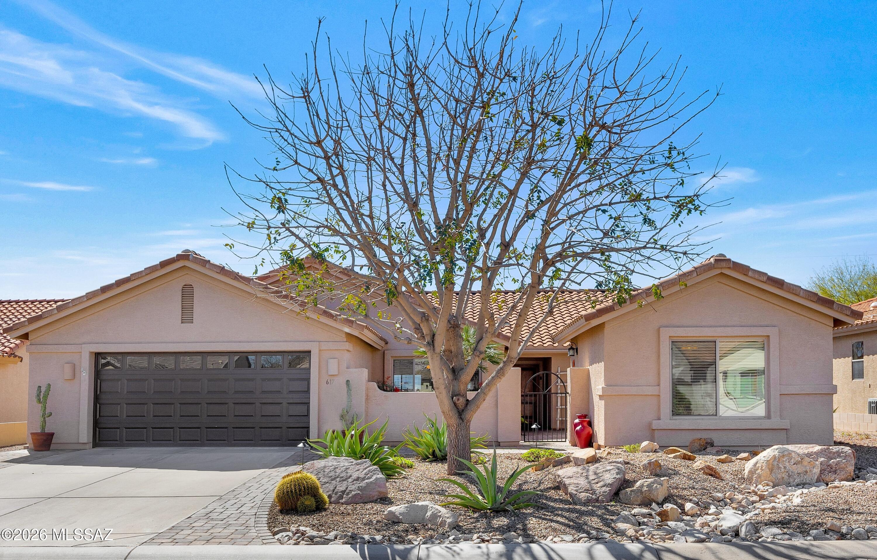 Enjoy mountain views from this Laredo with guest house & owned solar! Paver-lined driveway & walkway leads to custom front door. Spacious great room with slider to patio. Kitchen features granite counters, stainless steel appliances, island, pantry, & cabinets with slide-outs plus dining area. Owner's suite offers mountain views Ensuite bath with executive-height vanity, walk-in shower, & walk-in closet. Den/office. Guest bedroom with closet & nearby guest bath. Laundry room includes W/D & cabinets. Detached guest house includes mini split, service station with sink, closet, & bath with walk-in shower-ideal for guests. 2 car garage with 2020 W/H & cabinets. Covered patio & extended paver patio for great entertaining space. Backyard with fruit trees, lovely landscaping & mountain views!