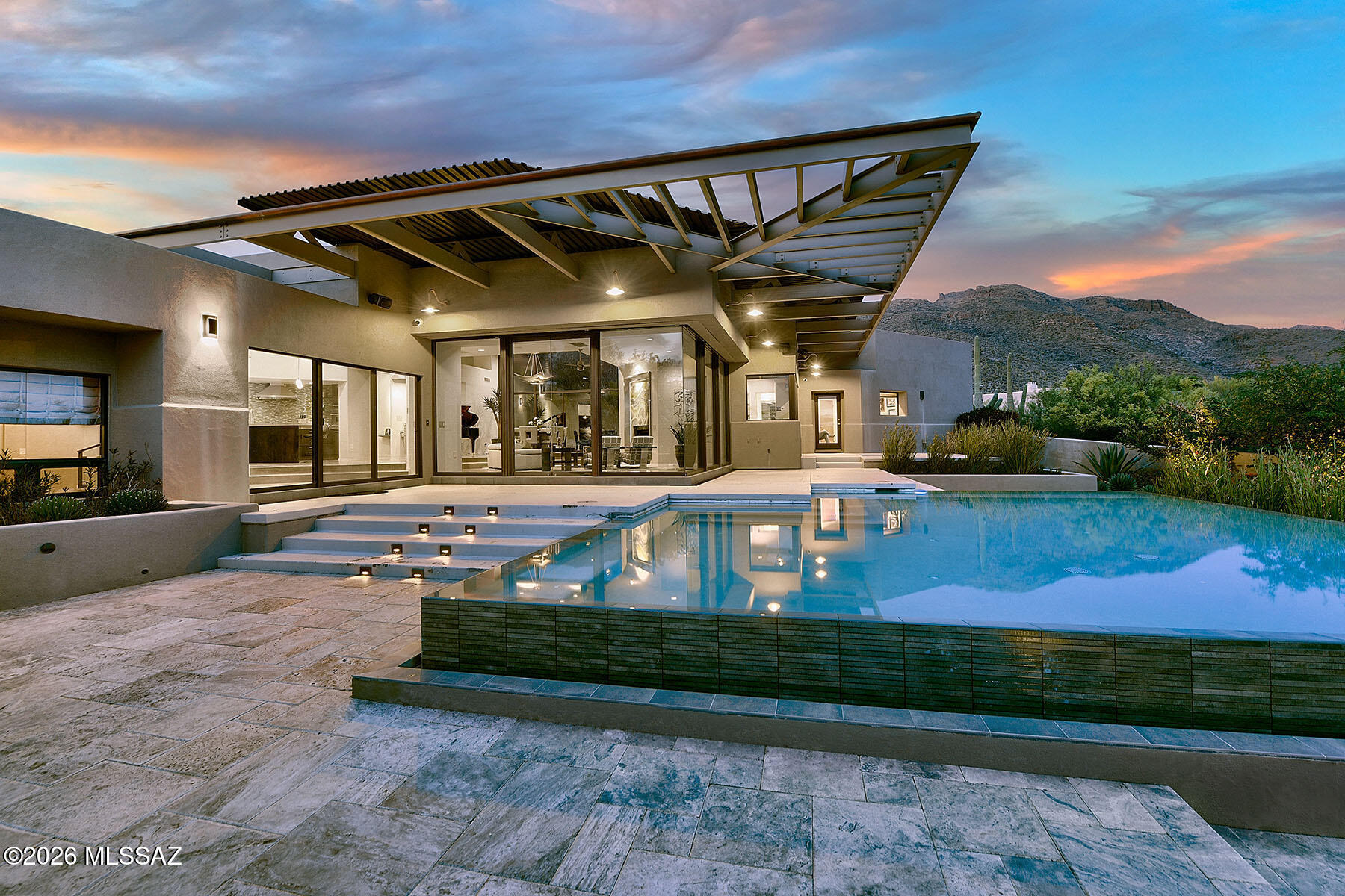 Stunning Architecturally Designed Pure Contemporary Style Home with magnificent
city & mountain views in prestigious gated Pima Canyon Estates, dramatic pivoting steel & glass entry door, interior design by Lori Carroll. 4,309 sq ft, exquisite Great Room with floor to ceiling windows, fireplace, dining room with breathtaking views, gourmet island kitchen with granite counter tops, stainless steel appliances, Viking 5 Burner gas stovetop, double ovens, GE Cafe refrigerator breakfast bar, pantry,  beautiful concrete floors, sensational media room with Wolf projector and 125'' screen , 3 bedrooms, 3 1/2 baths, sensational Primary Suite with sitting area, fireplace, private office with built-in bookcases, luxurious bath with granite countertops...... continued........ ........ under counter lighting, soaking tub, amazing designer tiled shower,  large walk-in closet & private entry to the rear patio. Special features include 4 air conditioning units, 4 gas furnaces, 2 hot water heaters, Fabulous resort like backyard with covered patio, negative edge heated pool & spa, metal canopies, outdoor kitchen, artificial turf, lush landscaping, 3-car garage, views, views, views!

Move in ready, All furniture is included in purchase price (piano not included) & Art work is negotiable!
