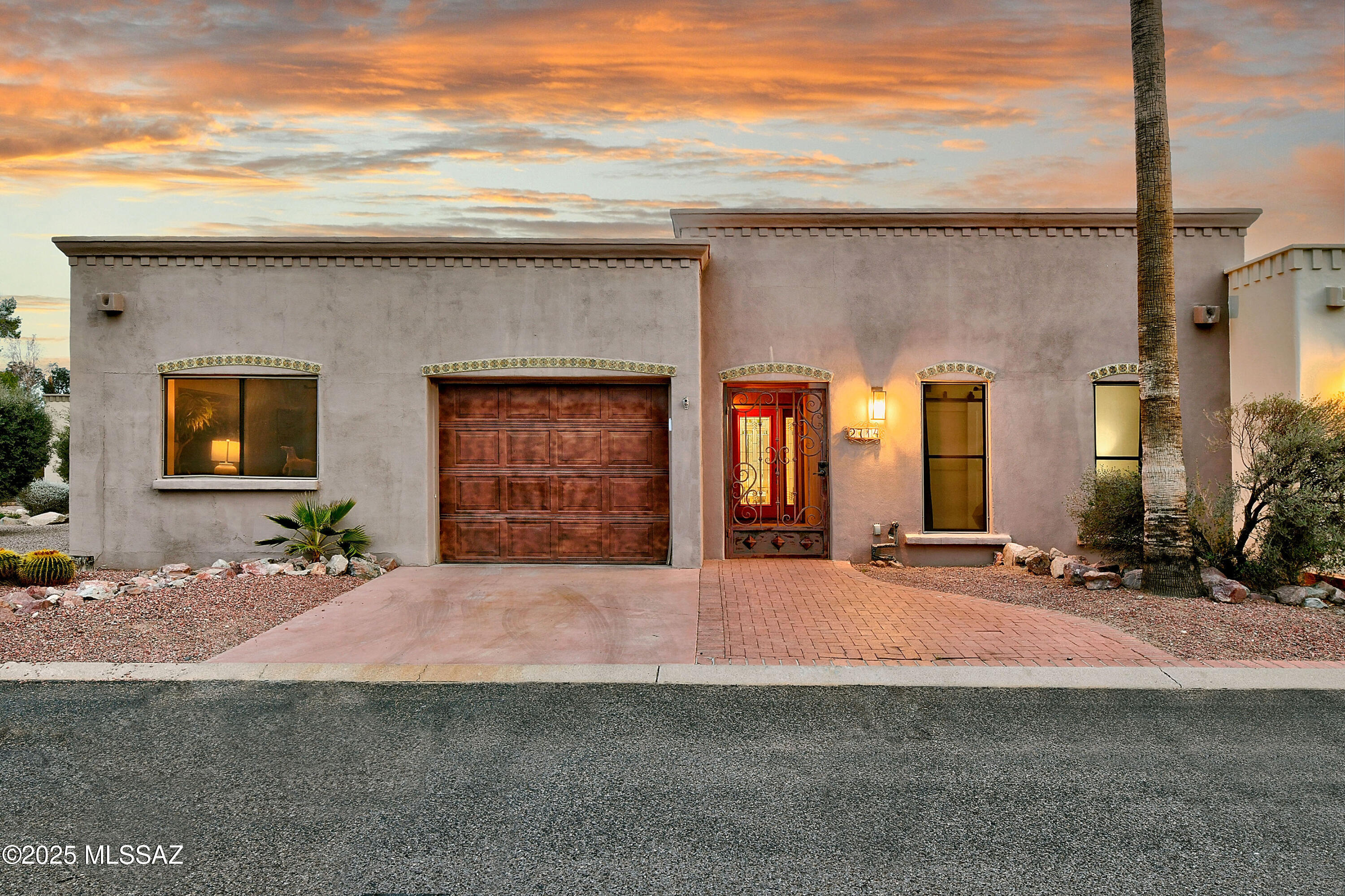 Stunning beautifully remodeled end unit -townhouse overlooking the 14th fairway of the prestigious gated OMNI Tucson National Golf Club. A privately gated front courtyard, exquisite Great room with walls of windows and French doors, lovely dining area, sophisticated gourmet kitchen with granite countertops, designer backsplash, custom cabinets, incredible gas range with dramatic glass lighted hood, stainless steel appliances, travertine tile floors throughout (no carpet),  3 bedrooms ( split plan), 2 baths including primary suite with sitting area, luxurious updated bath with granite countertops, double vanities, Jetted tub, large walk-in closet and private entry to the rear patio. Laundry room with washer & dryer and oversized one car garage w/storage room. Enjoy the fabulous large backyard with covered brick paver patio, Char-broil Medallion outdoor kitchen with bar area, granite countertops, built-in barbecue, refrigerator and sink, lush landscaping, gorgeous mature trees and great walking path to the golf course plus the sensational community pool & spa. Move right in!!!!