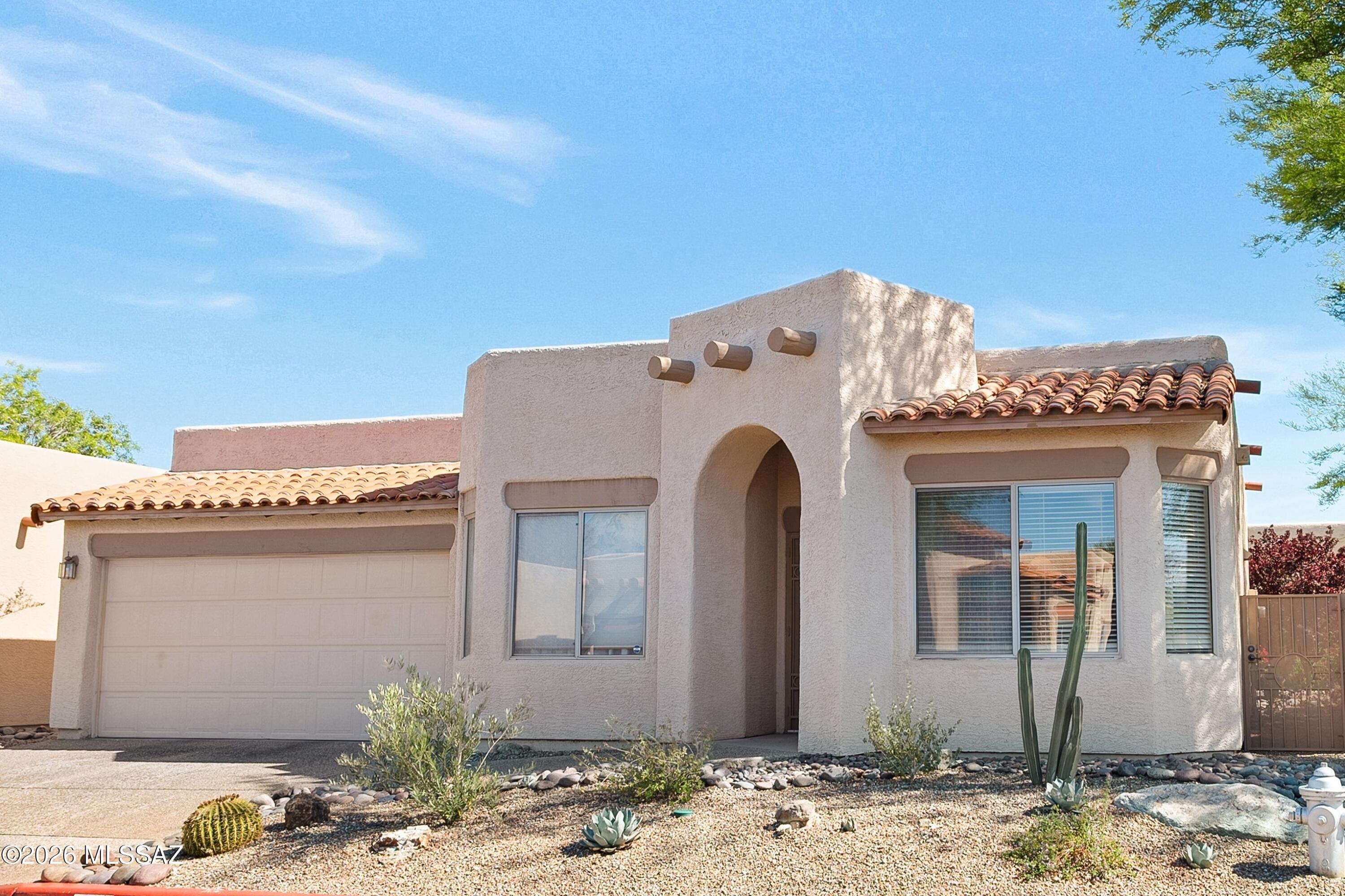 Warm, welcoming, and full of character-this Santa Fe-style 3/2 home in Crest Ranch on a corner-elevated lot offers the perfect blend of charm & functionality. An open-concept layout is anchored by a cozy fireplace, creating an inviting space to gather, while the versatile 3rd room with pocket doors easily transforms into a home office, yoga retreat or den. The bright eat-in kitchen features a pantry, breakfast bar, and effortless flow for everyday living. The spacious primary suite is a true retreat with direct backyard access and a spa-inspired bath complete with dual vanities, a soaking tub, separate step-in shower, and walk-in closet. Step outside to a beautifully designed, low-maintenance yard with covered patio and mature trees--ideal for entertaining or unwinding under the Tucson sky Crest Ranch residents enjoy a private pool, guest parking, and added peace of mind with 24-hour video surveillance. Perfectly positioned in central Tucson, this home puts you just minutes from the University of Arizona, Banner Medical Center, The Loop, St. Philip's Plaza, La Encantada, and favorite local spots like Trader Joe's. With quick access to I-10 and downtown, convenience is truly at your doorstep.
Opportunities in Crest Ranch are rare--this move-in-ready gem delivers timeless Southwest style and an unbeatable location.