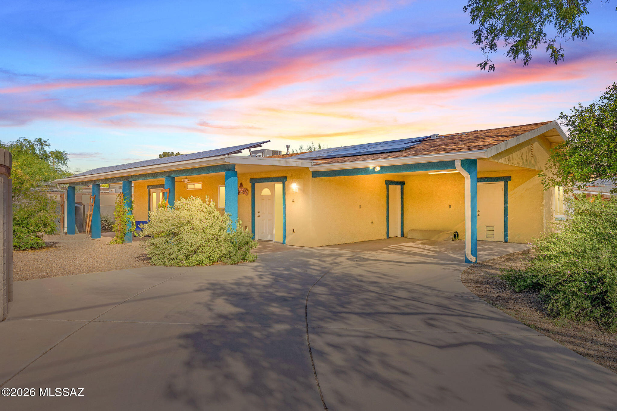 Unique opportunity for affordable 2007 custom built, rainwater-harvesting, single story, no stairs/no steps, 1,494 SqFt 3 bed/2 full bath split floor plan modern home with attached 2 car 307 SqFt covered carport, the freedom of no HOA, seller owned residential solar photovoltaic system (average electric bill just $27 per month), N/S orientation, Catalina mountain views, .16 acre R-1 lot with no Covenants, Conditions, or Restrictions, on and off street parking, spacious concrete driveway, security gated driveway surrounded by privacy fencing, located in the desirable Mcintyre - Richey neighborhood in thriving Central Tucson. 
Inside buyers will appreciate textured ceilings (no popcorn), gorgeous polished scored concrete floors throughout, energy efficient double pane windows, custom window blinds, new gas HVAC 2020 (with warranty), digital Honeywell thermostat, tankless water heater, recessed lighting, LED lighting, solar tubes, internal laundry room with washer and dryer included, 2-10 home warranty seller coverage, open concept kitchen with tiled bar seating, modern kitchen cabinets, stainless steel side by side refrigerator, gas stove, metal exhaust hood, faux full slab counter tops, large metal kitchen sink w/garbage disposal under garden window, massive walk-in pantry with built in storage, adjacent to spacious living room and dining area. Large guest bedrooms, updated full guest bathroom with executive height tiled modern vanity with tiled shower/tub. Spacious primary suite with door out to private covered patio, dual closets with updated ensuite full bathroom including executive height tiled modern vanity and tiled shower/tub.
Enjoy tranquil Tucson nights from under your 516 SqFt extended covered patio on concrete slab, plumbed for gas for grills, metal gutters feed into 1000 Gallon and 660 rainwater-harvesting cisterns, flower beds and metal storage shed, sewer clean outs, 200 amp electrical panel, mature vegetation with large mesquite tree, tangelo tree, and Sonoran cactus.
Convenient location walking distance to Rincon High School, minutes away from shopping and restaurants, El Con Mall and Randolph Park with 2X 18 hole golf courses, Rec Center, tennis and pickle ball courts, Reid Park Zoo, short drive to the University of Arizona, Tucson Medical Center, and Banner Medical. Call to make your appointment to view this beautiful move in ready home today!