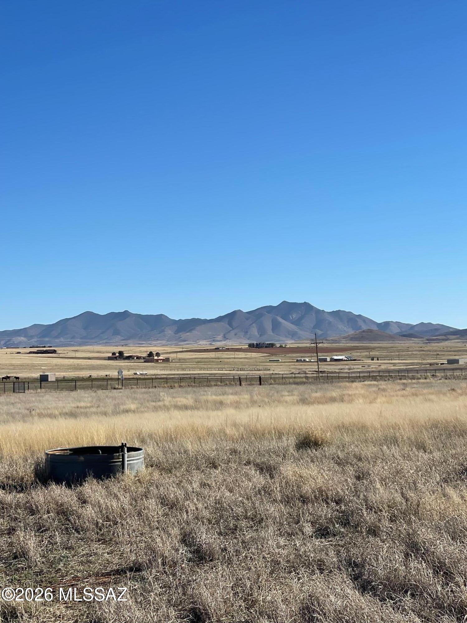 Flat usable lot with a well, seller will consider a split, Well is in unknow condition. Had been developed with fruit trees and Mobile home may years ago. Power line comes into the property. Fenced 3 sides.  Drive by and look at the views, easy access.