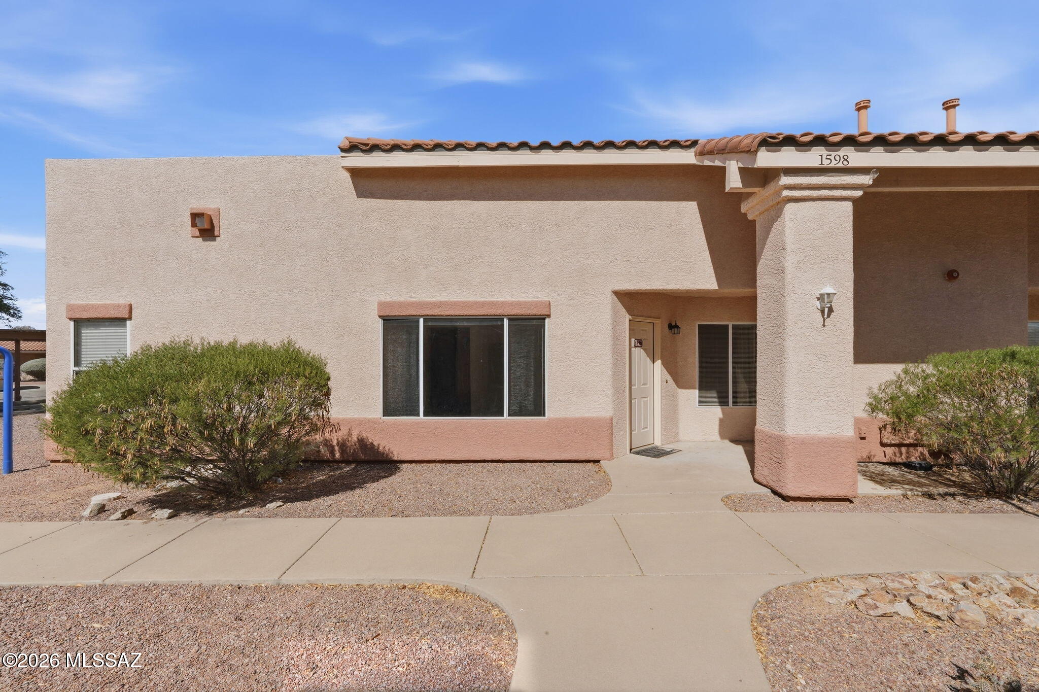 This is the perfect first time home, investment property or winter getaway! NO GVR but available! Open floor plan has 9' ceilings and oversized windows to let in loads of natural light. Kitchen has breakfast bar and separate dining area which opens up to spacious covered back patio, adding extra living space.  Large master suite with walk-in closet. Guest bedroom also has a walk in closet and own bath. Laundry located in oversized 2nd bath. Community Pool with spectacular views of the Santa Rita Mountains! Centrally located easy highway access, walk to farmers market and rec centers!