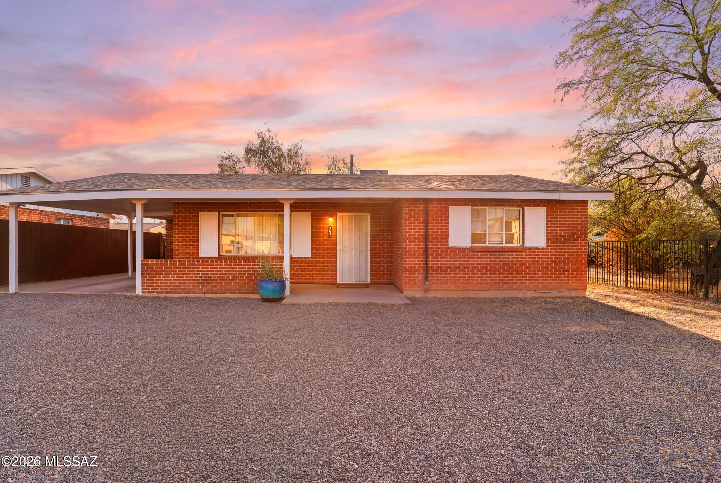 Charming 2BD/1BA mid-century brick home in a central location with easy access to everything Tucson has to offer. NO HOA! Set on a huge lot, the fully fenced backyard provides endless possibilities--ideal for gardening, play, entertaining, or adding a pool.

Light and bright interior with fresh paint, tile flooring throughout, and updated faucets. The home also features security doors on both the front and back for added peace of mind. Enjoy the convenience of a covered carport plus additional parking for vehicles or toys.  Spacious laundry room off the kitchen for extra storage/pantry plus an extra storage room off the patio.

Built solid and perfectly situated just minutes from restaurants, shopping, Tucson Medical Center and 15 minutes from the University of Arizona, with a nearby bus route for easy commuting.  All appliances convey, making this home MOVE-IN READY.