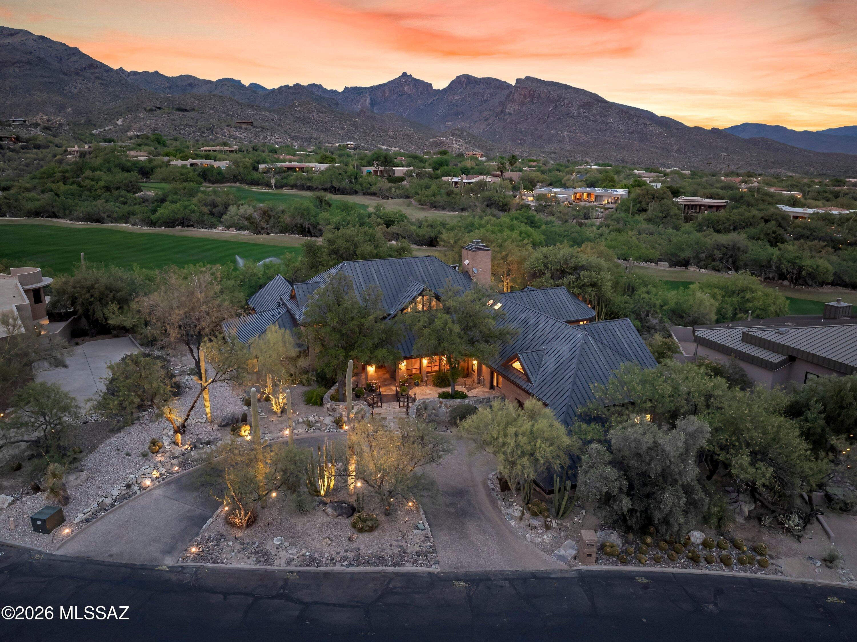 Commanding a premier vantage above the third fairway of the Canyon Course, this extraordinary Ventana Canyon estate is a masterclass in understated elegance and architectural distinction. Encompassing over 6,300 square feet, the residence is perfectly sited to capture uninterrupted golf course vistas framed by the dramatic Catalina Mountains.
Thoughtfully designed with five ensuite bedrooms and six baths, the home reflects exceptional craftsmanship, enduring materials, and a level of refinement that defines true luxury. Expansive interiors unfold with effortless grace--soaring living spaces, bespoke finishes, and a seamless balance between grand-scale entertaining and intimate everyday living.
The primary suite is a true private sanctuary, featuring a dedicated office or fitness retreat and dual full bathrooms--his and hers--offering exceptional space, comfort, and privacy, all oriented to embrace the home's breathtaking natural surroundings.

A 2-car garage, separate golf cart garage, and workshop provide exceptional utility without compromising elegance.

Outdoors, refined resort-style living awaits with a beautifully designed gazebo, expansive patios, a built-in barbecue and bar, and a striking fire pit--all set against sweeping fairway and mountain views, creating an atmosphere of privacy, sophistication, and effortless Arizona living.