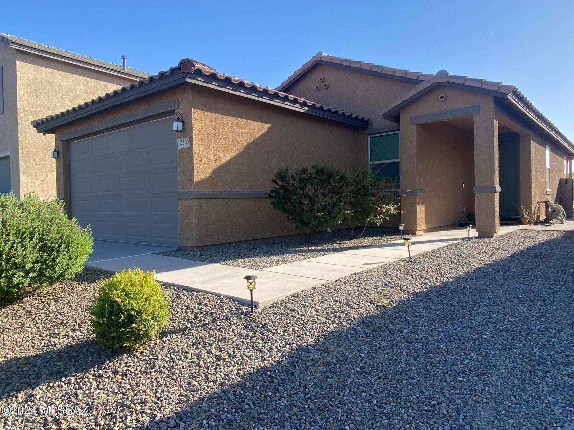 Incredibly comfortable 3 BR 2 BA 2 Car Garage with immaculate rear yard of artificial grass and uni-block table area for entertaining and walkway to side gate. Mailboxes a few feet away with community park just down the road. Make this wonderful home yours and move into this beautiful newer community. Walking Trails and open walkways. Spacious rear yard affords relaxing while taking in the glorious sunsets.