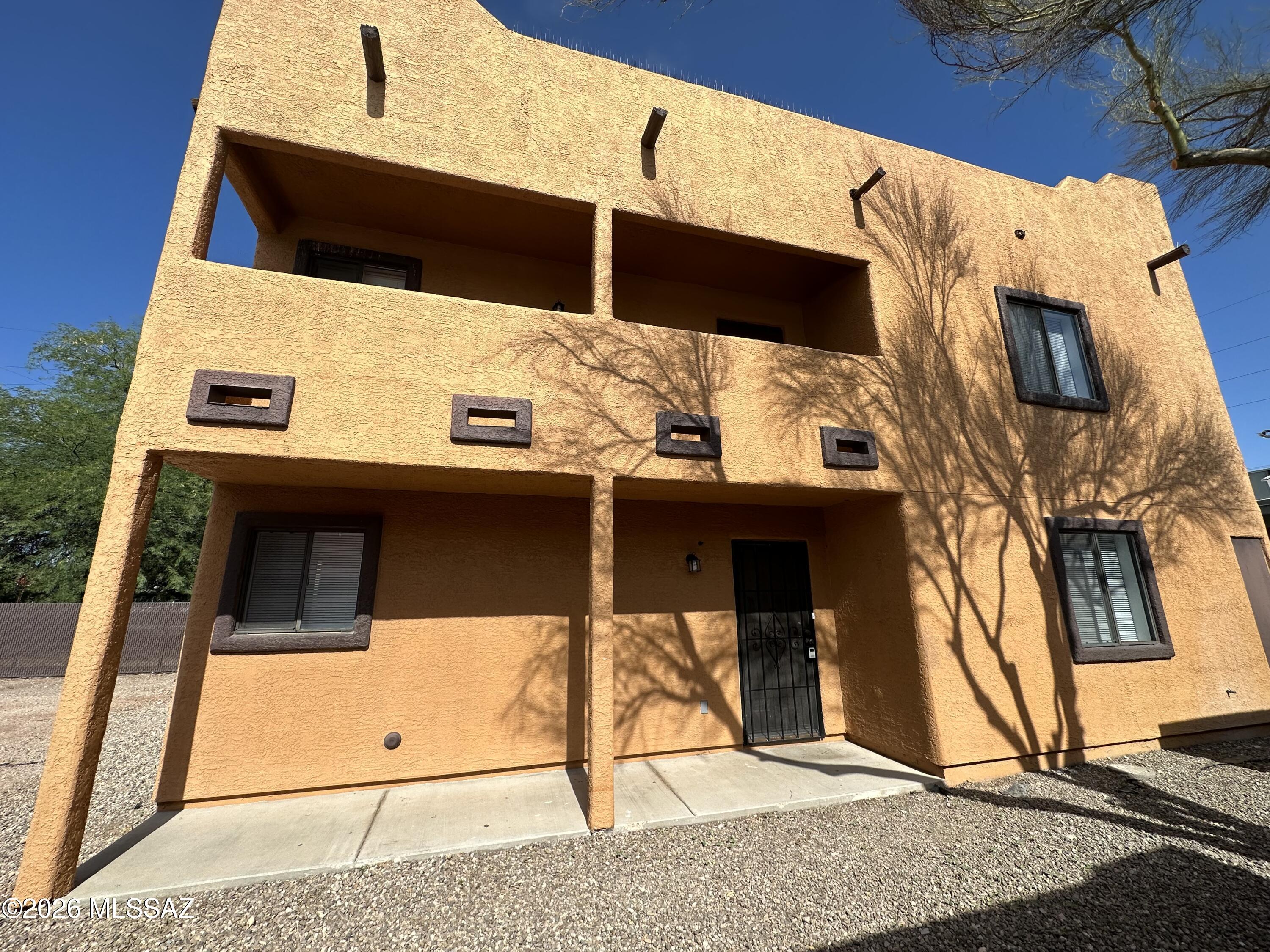 This two-story home is just east of Grant and first, close to shopping, downtown and U of A! Three bedrooms and a balcony upstairs, and one bedroom and full bath downstairs. Tile floors everywhere but wood on stairs and carpet in upstairs bedrooms. Open kitchen, plenty of parking. Tenant occupied until 5/31/26