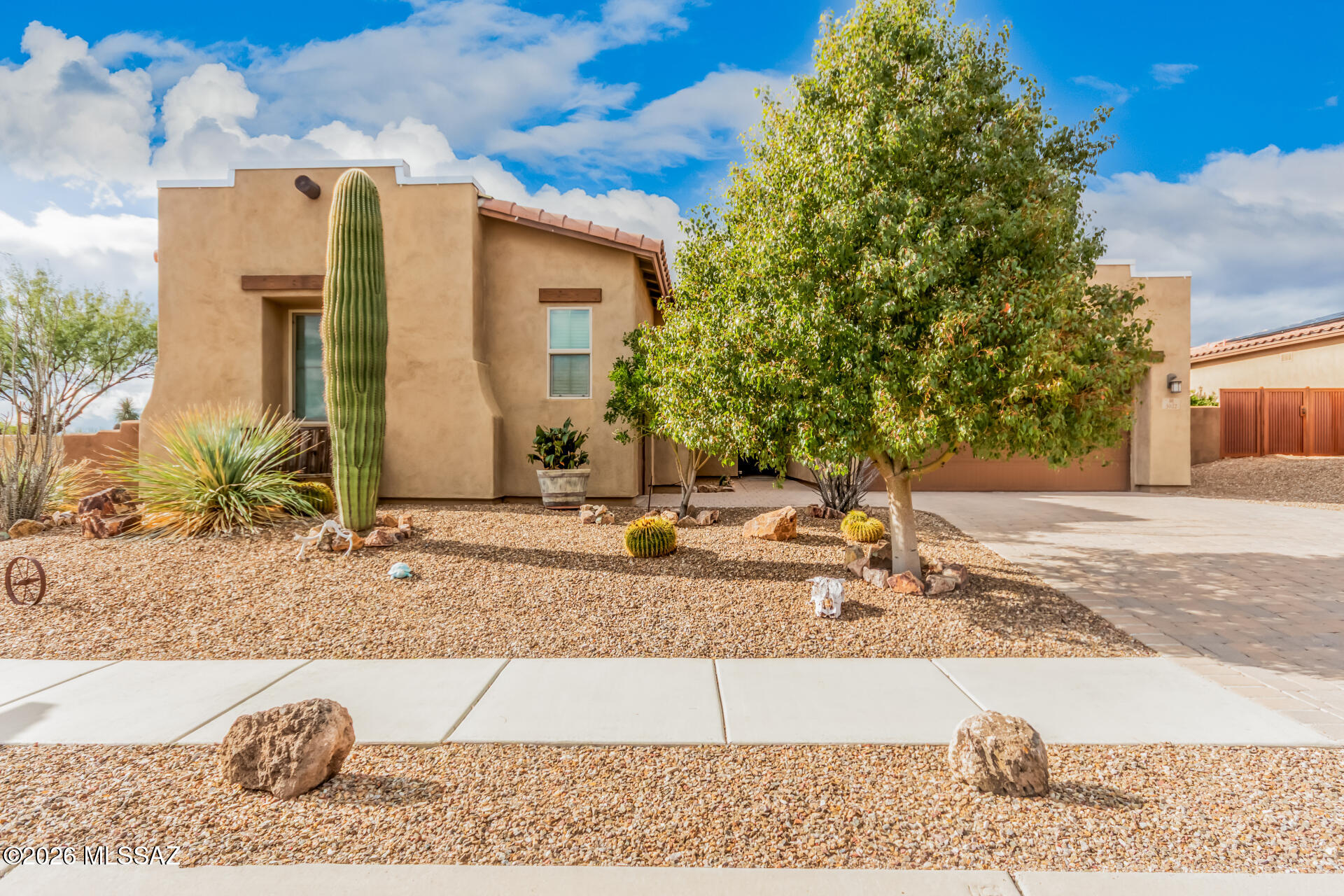 Range priced $499,000-$520,000. Proudly own this beautiful 4-bedroom home on a desirable corner lot in a vibrant community. Featuring a 3-car garage, paver accents, and low-maintenance desert landscaping, this home welcomes you with high ceilings, wood-look flooring, and a bright, open living space. The gourmet kitchen offers granite countertops, stainless steel appliances, crown-molded cabinetry, and a large island with breakfast bar. A versatile den is perfect for a home office or lounge. The spacious primary suite includes a sitting area, dual sinks, and a walk-in closet. Enjoy stunning mountain views from the covered patio. Ideally located near Star Pass Golf Course, Tucson Mountain Park, miles of hiking trails, & nearby community activities--this home offers the best of Tucson living.