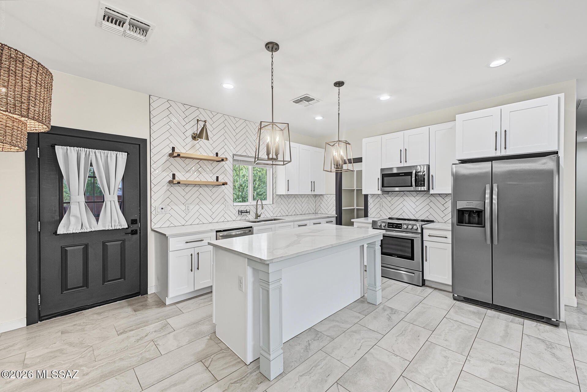 Seller will accept or counter offers between $500,000 - $525,000. 3D Matterport & Floor Plan available. This charming residence on over an acre in Tucson is the one! NO HOA! Nestled on a desirable corner lot, it features a desert landscape and a 2-car garage w/extended driveway. Inside, you'll find high ceilings, tons of natural light, tile flooring, recessed lighting, and an excellent open floor plan with a generous living area. The eat-in kitchen boasts crisp white shaker cabinetry, quartz countertops, tile backsplash, SS appliances, and an island w/breakfast bar. The primary bedroom includes a private bath w/custom penny-tiled shower and a walk-in closet. A secondary bedroom also features an ensuite w/dual sinks for added convenience. Owner is licensed Real Estate Agent in AZ.