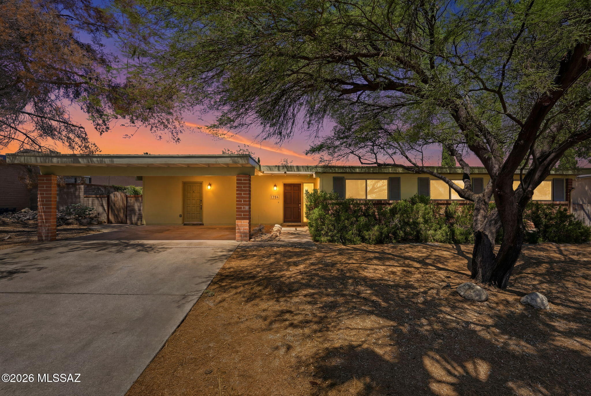 Affordable opportunity for updated 1,786 SqFt 3 bed/2 full bath plus den, Mid-Century Modern burnt adobe 1973 ranch home on .20 acre R-1 lot with no neighbors directly behind, the freedom of No HOA, in desirable Hidden Hills neighborhood located in Northeast Tucson. Ideal for first time homebuyers, Air-bnb property, seasonal visitors, parents looking to secure student housing and investors alike! Featuring E/W orientation, single story, no stairs/no steps, Catalina mountain views, spacious concrete driveway, front 360 SqFt covered 2 car carport w/power, concrete sidewalks, on and off street parking, space for camper/small RV parking, metal gutters, mature mesquite and pine tree. Sellers completed $93K worth of recent repairs/upgrades from professional restoration company, ready for new owners to enjoy! Inside buyers will appreciate energy efficient double pane windows, freshly painted, textured painted ceilings (no popcorn), copper plumbing, 18' diagonal tile with brand new carpet in bedrooms, Trane gas HVAC, digital thermostat, gas water heater, wired for alarm, large internal laundry/mud room with washer/dryer included along with extra storage cabinets, concrete wood burning fireplace w/gas insert in spacious living room, den/formal dining area could be converted into 4th bedroom, updated modern open concept kitchen with faux concrete Corrin countertops, bar seating, updated chocolate kitchen cabinets, gas stove, dishwasher, double metal sink w/garbage dispenser adjacent to family room with bank of wood French doors providing fantastic natural light, leading out to extended covered patio. Updated full guest bathroom with executive height modern vanity, exhaust fan and tiled shower/tub. Spacious primary suite with slider out to extended covered patio and private ensuite full bathroom w/pedestal sink, exhaust fan and tiled walk in shower.
Enjoy tranquil Tucson sunsets under West facing 754 SqFt extended covered backyard patio with saltillo tile flooring, 200 AMP electrical panel, gated alley access for toys (no HOA) surrounded by block privacy walls. Current Truly Nolen $3,042 termite treatment and warranty thru 10.31.26.
Fantastic Northeast Tucson location minutes away from Tucson Country Day School, Desert Christian School, Agua Caliente Wash and groceries/shopping/restaurants. Quick access to Houghton Road, providing commute to Northwest Medical Center, Saguaro National Park, Davis-Monthan Air Force Base and Raytheon. Call to make your appointment to view this move in ready home today!