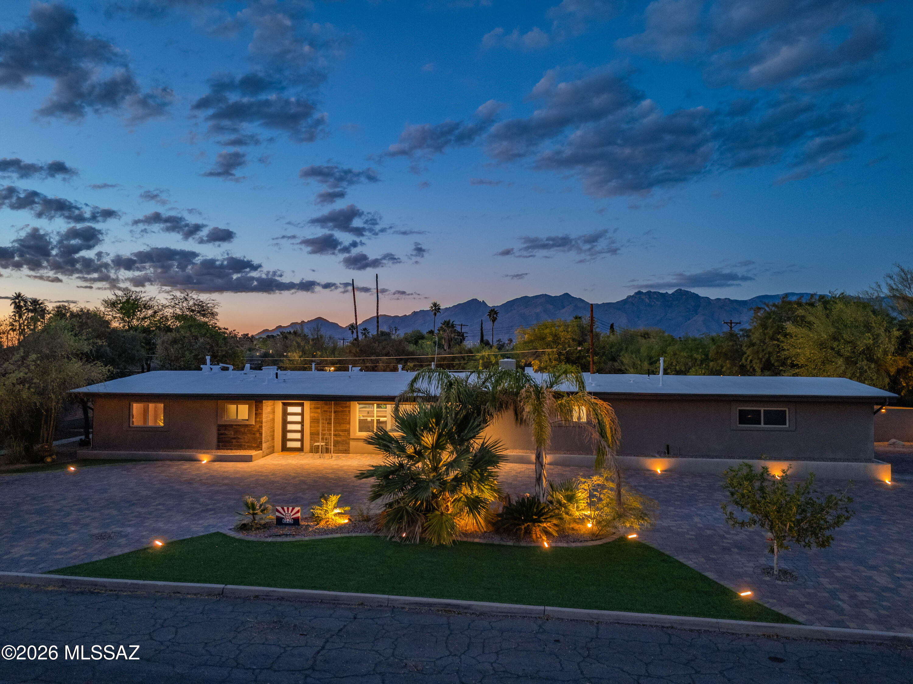 Experience Tucson living at its best in this thoughtfully designed 4 bedroom, 3 bathroom home featuring two true primary suites and a layout built for both comfort and flexibility. From the moment you walk in, the open concept living space feels bright, inviting, and ready for everyday living or entertaining. The kitchen is a standout with generous counter space, dual ovens, and abundant storage. Just off the main kitchen, a separate secondary prep kitchen and pantry space offers incredible versatility, perfect for entertaining, meal prep, or ideal for those seeking a kosher style kitchen setup. Step outside and you will find where this home truly shines. The backyard is a private retreat with a sparkling pool featuring an electric rolling cover, expansive patio space, multiple cover seating areas, and even a putting green. Whether hosting friends or enjoying a quiet evening under the lights, this yard is designed to impress.



The fully paved driveway adds both curb appeal and function, offering plenty of parking space for guests, toys, or multiple vehicles. Conveniently located close to shopping, dining, and everyday amenities while still offering a private and peaceful setting. Additional features include a 2 car garage, functional built ins, and a flexible floor plan that adapts to your needs. This is more than a home, it is a space designed for how you actually live.