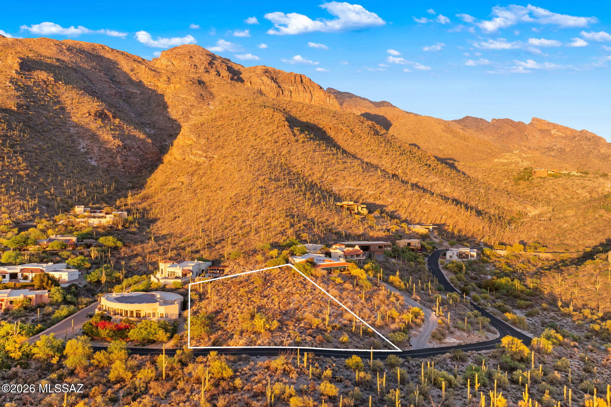 An extraordinary opportunity to craft a world-class custom estate atop the prestigious Sin Vacas community. This exceptional homesite captures sweeping, unobstructed mountain, city, and sunset views, offering a truly breathtaking backdrop. Nestled in a private, gated enclave, the lot provides the perfect balance of serenity, exclusivity, and sophistication. Surrounded by the pristine beauty of the Sonoran Desert, yet moments from fine dining, upscale shopping, and premier amenities, this is desert luxury living at its finest. Experience luminous sunrises and dazzling city lights from your future residence in one of the area's most coveted addresses.