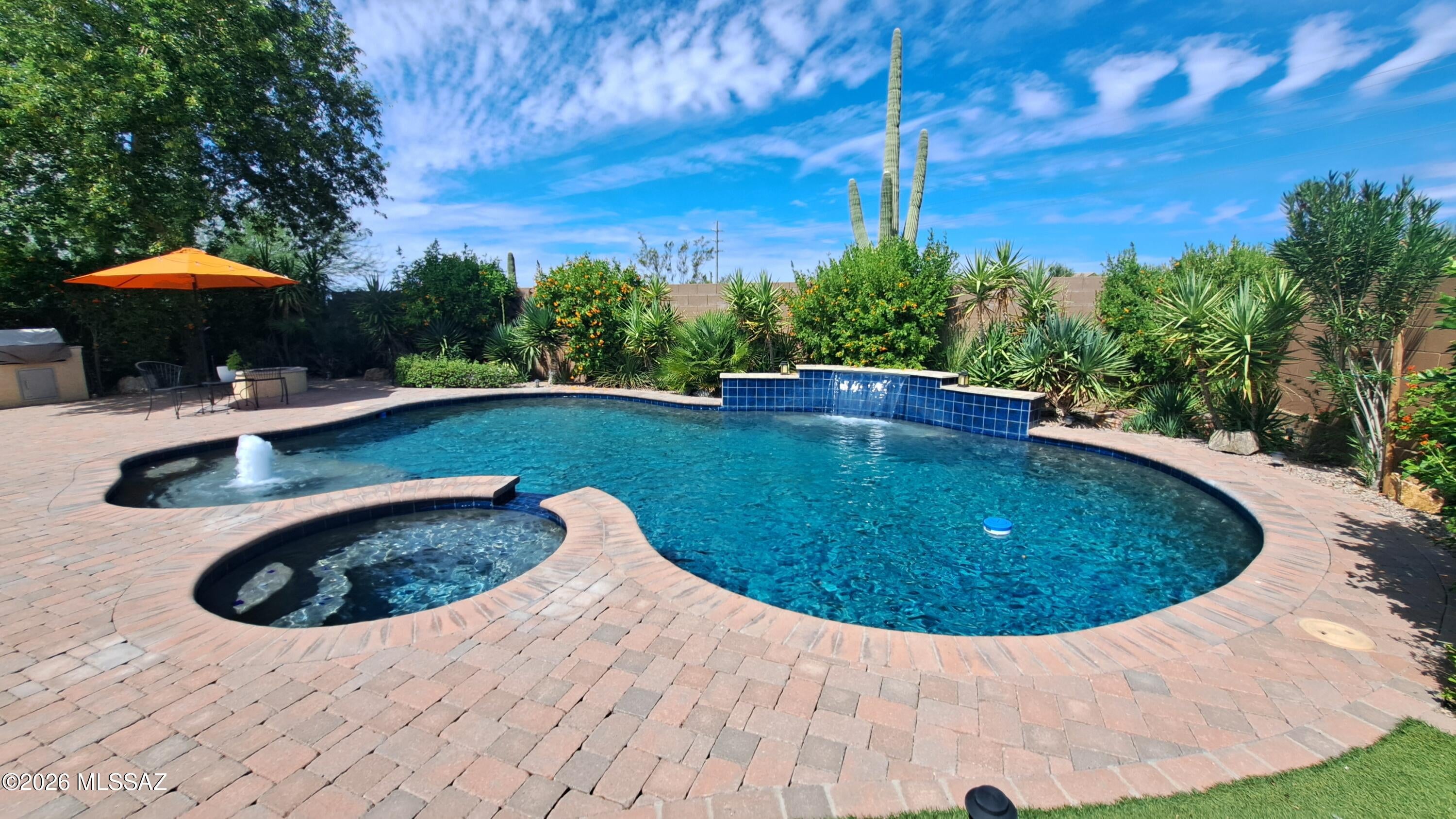 Stunning upgraded home in Casa Sevilla. This single story Pulte home is better than new! Enter the open concept home featuring beautiful engineered hardwood floors, 10' ceilings, plantation shutters, recently upgraded kitchen cabinets and SS appliances. The adjacent family room has a cozy fireplace for those cooler evenings. The beautiful professionally landscaped backyard showcases a sparkling heated pool and relaxing spa. A built-in Bull barbeque grill, built-in gas fire pit and tranquil waterfall add to a year round enjoyment. Located on a cul-de-sac and short distance to Tangerine Sky Park, shopping and dining.