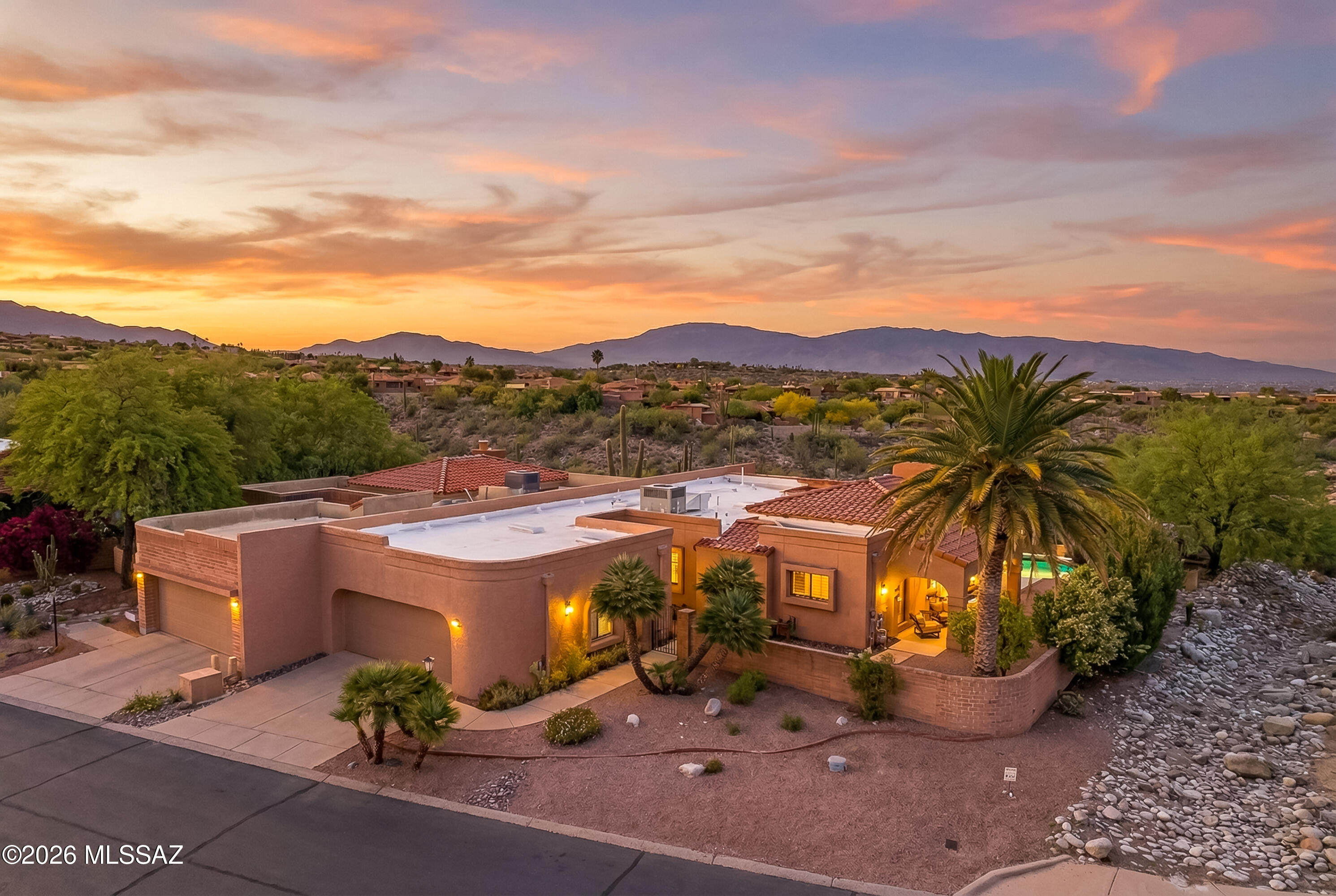 Experience privacy and panorama in this lovingly maintained 3BR/2BA home. Nestled along the ridgeline, this home is uniquely positioned with no neighbor to the south, offering a secluded backyard. Whether you're relaxing by the private pool or lounging under the patio, you'll see stunning views!! Inside, the living room features a fireplace and large windows that frame the poolside scenery. Beyond the views, this property offers peace of mind thanks to some recent, high-ticket upgrades such as a new roof (rolled portion in 2022 / tile in 2023), a new HVAC installed in Dec, 2024, and the water softener & water heater were replaced in 2023. While the community provides two pools, the luxury of your own pool means you never have to pack a bag to cool off. Some furniture is available for sale. This property is also close to so many amenities:  shopping, dining and bike riding the Loop all at River and Craycroft!