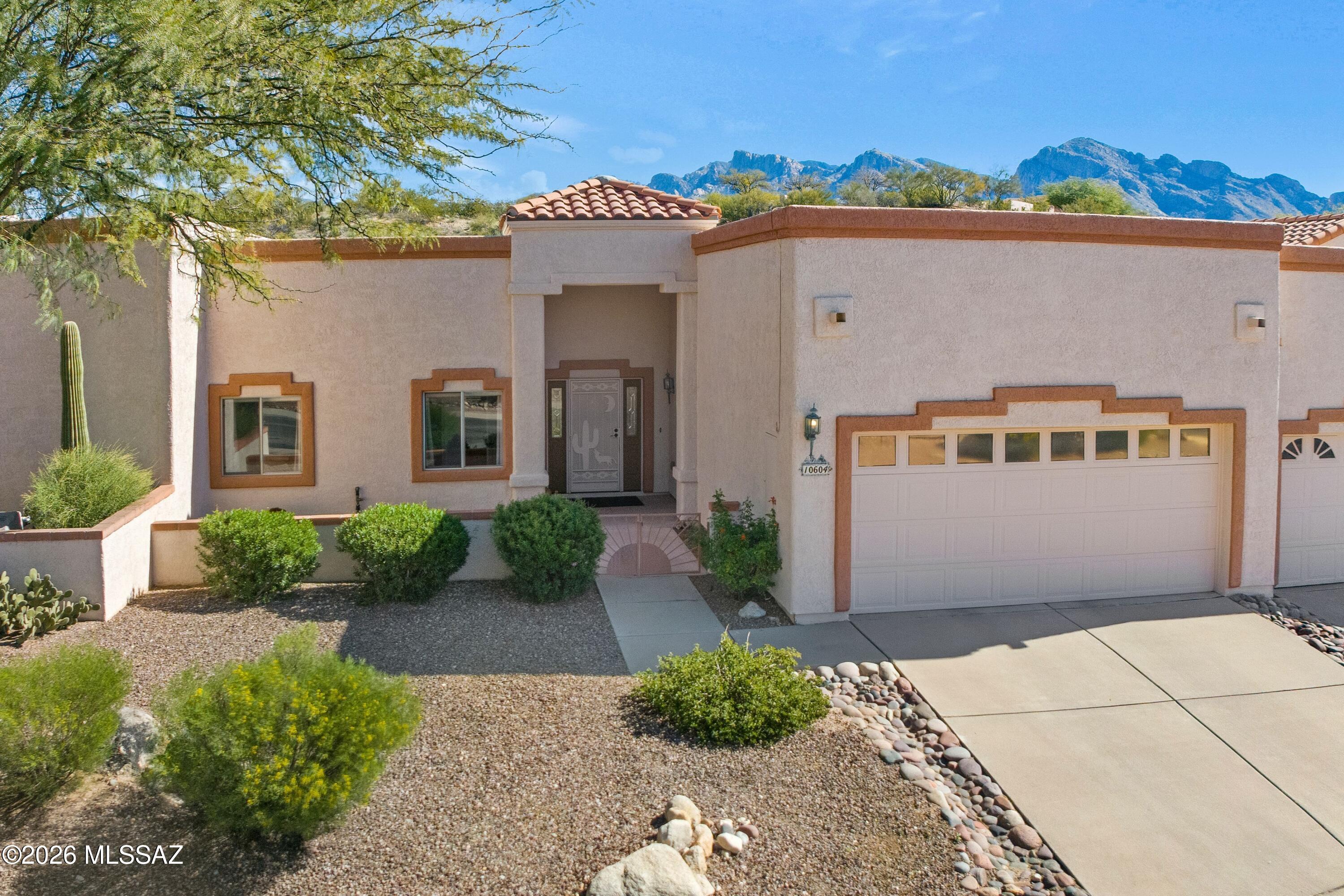 Welcome to Laughing Coyote, where the gates close behind you, and the peaceful desert lifestyle begins. This truly wonderful townhome backs to open space (that's right... no neighbors behind), giving you the privacy you have desired. Inside, the home feels both warm and thoughtfully designed. An inviting Arizona room adds flexible living space, while charming built-in nooks are ready for your favorite books, art, or curated treasures. The kitchen means business with granite countertops, stainless steel appliances, double ovens (party hosting approved), and an electric cooktop. Fresh paint and abundant natural light keep the space light and bright.HOA covers Exterior painting and roof. The oversized two-car garage with storage cabinets checks the "where do we put everything?" box, while the extra-large laundry room and versatile bonus room offer space for hobbies, crafts, or the home office you've been meaning to set up. Private. Serene. Perfect lock-and-leave for part-time stays, yet spacious and comfortable enough to enjoy full-time. Whether you're a seasonal visitor or planting roots in Oro Valley, this home offers the flexibility to live exactly how you want. Yes... This one is worth a look.