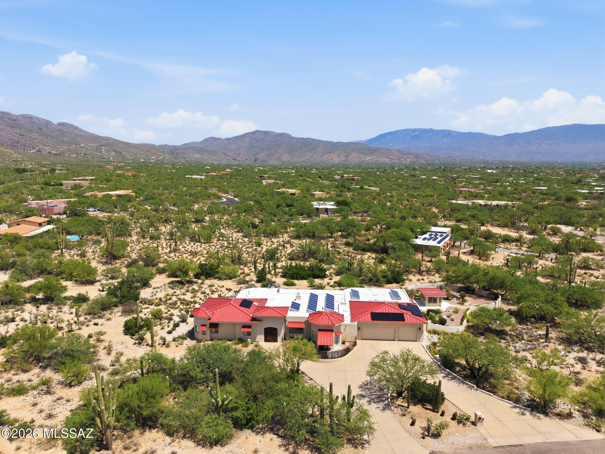 Custom multigenerational estate engineered for comfort, luxury, and true energy independence! Featuring a split floor plan with massive en-suite bedrooms, open central kitchen, massive 23'x31' private library, separate office with mountain views, and a 33' Arizona Room. Powered by a net-metered solar array with TWO Tesla Powerwalls and backup generator--owner receives TEP credits with $0 power bills! Sprawling lot offers space for a pool, horse facilities, or secondary structures. Located in a top school district near Sabino High and Tanque Verde High. CUSTOM-BUILT MULTIGENERATIONAL HOME WITH OWNED SOLAR, TESLA POWERWALLS & PANORAMIC MOUNTAIN VIEWS

Designed with exceptional attention to space, function and long-term livability, this custom-built single-level home at 10401 E Plumeria Rd offers a rare combination of multigenerational flexibility, energy-efficient systems, oversized living spaces and beautiful high-desert surroundings.

The home was thoughtfully designed by the owner to accommodate multiple living arrangements, including dedicated areas for extended family, guests or live-in care. Its expansive split floor plan provides separation and privacy while maintaining comfortable shared living and gathering spaces.

ENERGY INDEPENDENCE

A major feature of the property is its fully owned, net-metered solar system, paired with two Tesla Powerwall battery storage units and an integrated standby generator. According to the seller, the system has historically generated TEP rate credits and substantially offset the home's electrical costs. Battery storage and generator backup add another layer of energy security during outages or grid disruptions.

EXPANSIVE INTERIOR LIVING

At the center of the home is a spacious kitchen with abundant counter space, a large pantry and sunny breakfast nook. The kitchen flows naturally into the formal dining area and expansive great room, creating an inviting setting for everyday living and entertaining.

The light-filled great room features high ceilings and views of the surrounding desert landscape.

A remarkable 33' x 13' glass-enclosed Arizona Room extends the living space and offers flexibility as a year-round indoor/outdoor retreat, exercise area, game room, hobby space or additional gathering area.

One of the home's most distinctive features is its impressive 23' x 31' private library. With exceptional scale and flexibility, the room could also serve as a media room, creative studio, collection space or specialized home office.

A separate executive office provides a quiet workspace with panoramic views toward the Catalina and Rincon Mountains and the surrounding Sonoran Desert.

MULTIGENERATIONAL & FLEXIBLE DESIGN

The split-wing floor plan includes exceptionally spacious bedroom suites with private bathrooms and walk-in closets. The layout offers excellent flexibility for extended family, long-term guests, caregivers or households seeking greater separation between living areas.

HIGH-DESERT SETTING & OUTDOOR POTENTIAL

The expansive property offers privacy, open desert surroundings and room to create an outdoor environment tailored to the next owner's lifestyle. There is generous space for a future pool, spa, outdoor kitchen, workshop, equestrian improvements or other permitted improvements.

Enjoy dramatic mountain views, colorful Arizona sunsets and dark desert skies from this peaceful East Tucson setting.

LOCATION

Located in an established Northeast Tucson neighborhood, the property combines a private high-desert setting with convenient access to shopping, dining, golf, hiking and biking opportunities. Sabino Canyon Recreation Area, Catalina Highway and other Northeast Tucson amenities are within convenient reach. The property is also located near Sabino High School and Tanque Verde High School.

HIGHLIGHTS:

" Custom-built, single-level design
" Multigenerational split floor plan
" Oversized bedroom suites with private baths and walk-in closets
" 23' x 31' private library/flex space
" Dedicated executive office with mountain and desert views
" 33' x 13' glass-enclosed Arizona Room
" Spacious kitchen, pantry and breakfast nook
" Fully owned net-metered solar system
" Two Tesla Powerwall battery storage units
" Integrated standby generator
" Expansive high-desert property
" Catalina and Rincon Mountain views
" Space for future pool, outdoor living, workshop, equestrian or other permitted improvements
" Convenient Northeast Tucson location