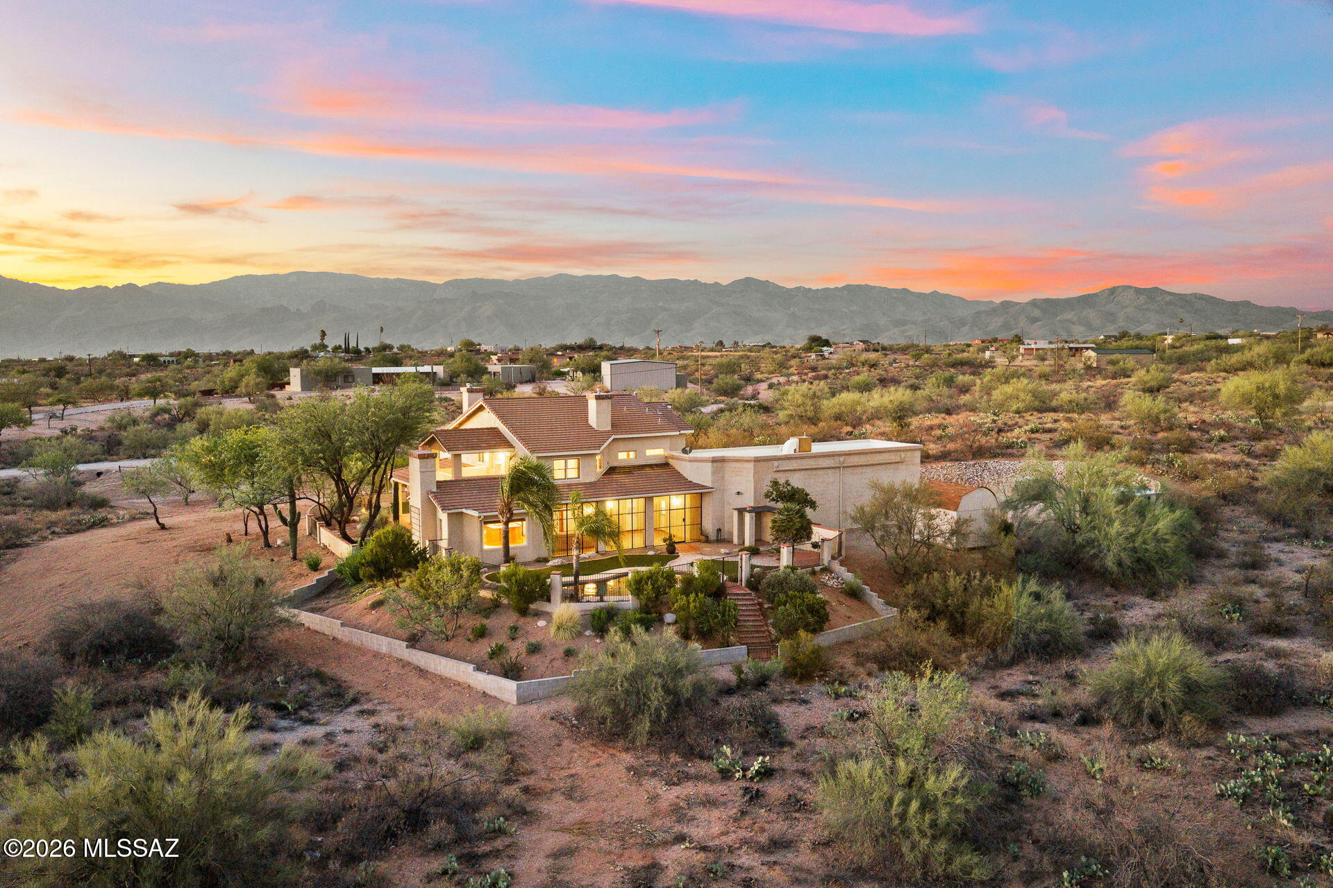 Experience the beauty and tranquility of the Sonoran Desert from this exceptional one owner custom home, perfectly situated on 8.2 private acres surrounded by breathtaking mountain views, towering saguaros, and Arizona's natural beauty. 
Offering 3,547 square feet of thoughtfully designed living space, this 4-bedroom, 3.5-bath residence blends timeless craftsmanship with comfort, flexibility, and the room to create the lifestyle you've always envisioned. 
Step through the front door and be welcomed by rich hardwood flooring, a dramatic grand staircase, and an inviting floor plan designed for both everyday living and effortless entertaining. The main level features two spacious guest bedrooms connected by a convenient Jack-and-Jill bathroom, multiple gathering spaces including both a form living room and a warm family room, each complete with its own fireplace which provide the perfect setting for relaxing or entertaining family and friends.
Upstairs, a spacious loft with its own fireplace creates an ideal second living area or quiet space. The private primary suite is a true retreat, featuring a luxurious spa-inspired bathroom with a classic clawfoot soaking tub perfectly positioned beside a stunning see through fireplace, a large walk-in shower, dual vanities, and an oversized walk-in closet. A second upstairs bedroom includes its own ensuite bath, offering privacy and comfort for guests or extended family.
The  basement adds valuable flexible space that can easily serve as a game room, fitness area, home theater or additional storage.
Outside, the property truly shines. The backyard is designed for enjoying Southern Arizona's incredible weather, featuring a sparkling pool with a cascading waterfall, expansive artificial turf, and sweeping mountain views that create an unforgettable backdrop for outdoor living. Additional turf in the front yard enhances curb appeal while minimizing maintenance.
The oversized two-car garage is complemented by an attached RV garage, providing exceptional storage for recreational vehicles, boats, or workshop space. Three additional storage sheds are strategically placed throughout the property, offering even more room for tools, equipment, and hobbies. 
Zoned for horses, this remarkable property offers endless opportunities to customize your dream estate. Whether you envision equestrian facilities, a detached workshop, gardens, or even a guest house, the acreage provides the space and flexibility to bring your vision to life. Despite its peaceful, private setting, you'll enjoy the convenience of being just minutes from Saguaro National Park, shopping, dining, and everyday amenities. 
This is more than just a home, it's a rare opportunity to own a private Sonoran Desert estate where luxury, serenity, and limitless potential come together.

DO NOT FOLLOW GPS: Take Old Spanish Trail east from Houghton to Avenida los Reyes,Take a right on Avenida Los reyes and take it to the end,Make a left onto Pantano Trail and take it to the end to the brown wooden fence,Make a right at the brown wooden fence to the house on the right.