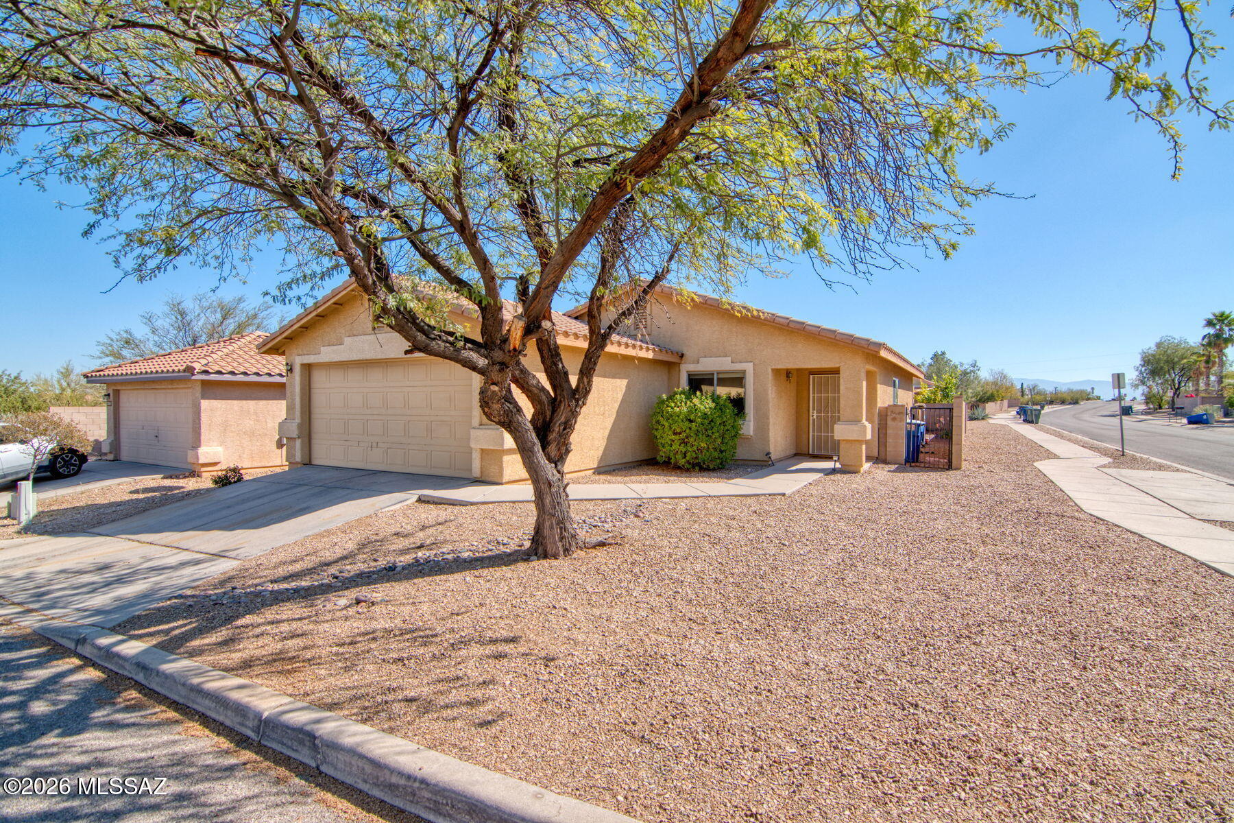This home has so many things to love! This move-in ready home is updated, maintained and has a very low HOA. The peaceful neighborhood has walking and bike paths nearby and has close access to newly updated parks, I-10, Downtown and U of A. Beautiful tile is featured in this 3 bedroom home with an extra large primary bedroom with a walk-in closet and bath with double sink vanity. High ceilings, both a breakfast nook and dining area along with a comfortable living room will make you feel right at home. Extra features include an upgraded AC installed in 2022 and newer hot water heater along with a water softener. Wait until you see the large backyard with a covered patio, turf playard, and natural desert landscape. Come see this beauty today!