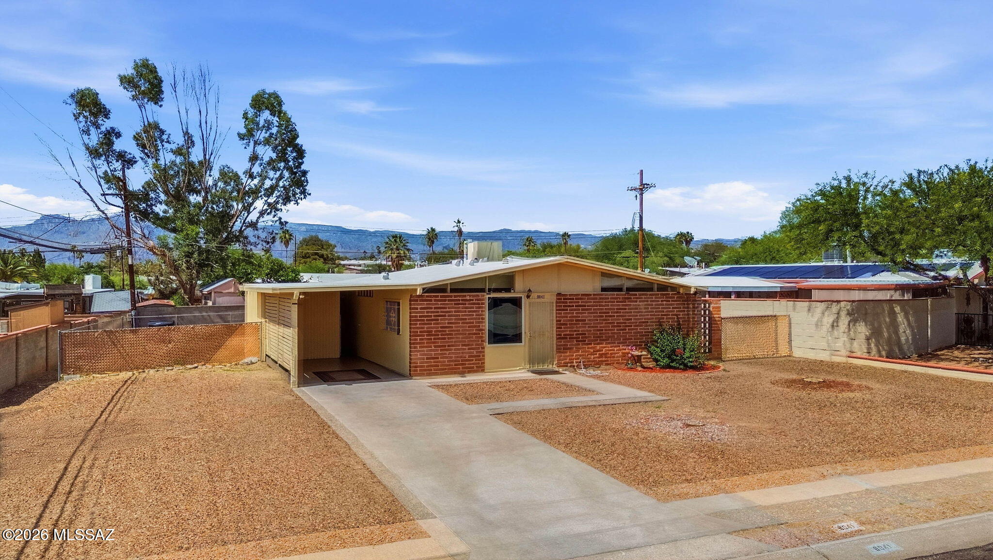 Welcome to 8041 E Julia St, a well maintained mid century 3 bedroom, 2 bathroom home located in Tucson's East side with no HOA and assumable 2.75% rate. This home features a bright and inviting living room, ample windows, new carpet, new interior/exterior paint, and ceiling fans throughout. Kitchen includes stainless steel appliances, laminate countertops, electric range, mosaic backsplash, overhead exhaust fan, wood cabinetry and pantry. This property has a full length covered patio, low maintenance backyard and recently coated roof making it easy to upkeep. Enjoy the convenience of your own covered carport, large storage shed and 8,500 sq/ft Lot allowing for plenty of additional vehicle or RV parking. With plenty of restaurants, parks, retail and grocery stores nearby, this home is sure to please. Schedule your private showing today!