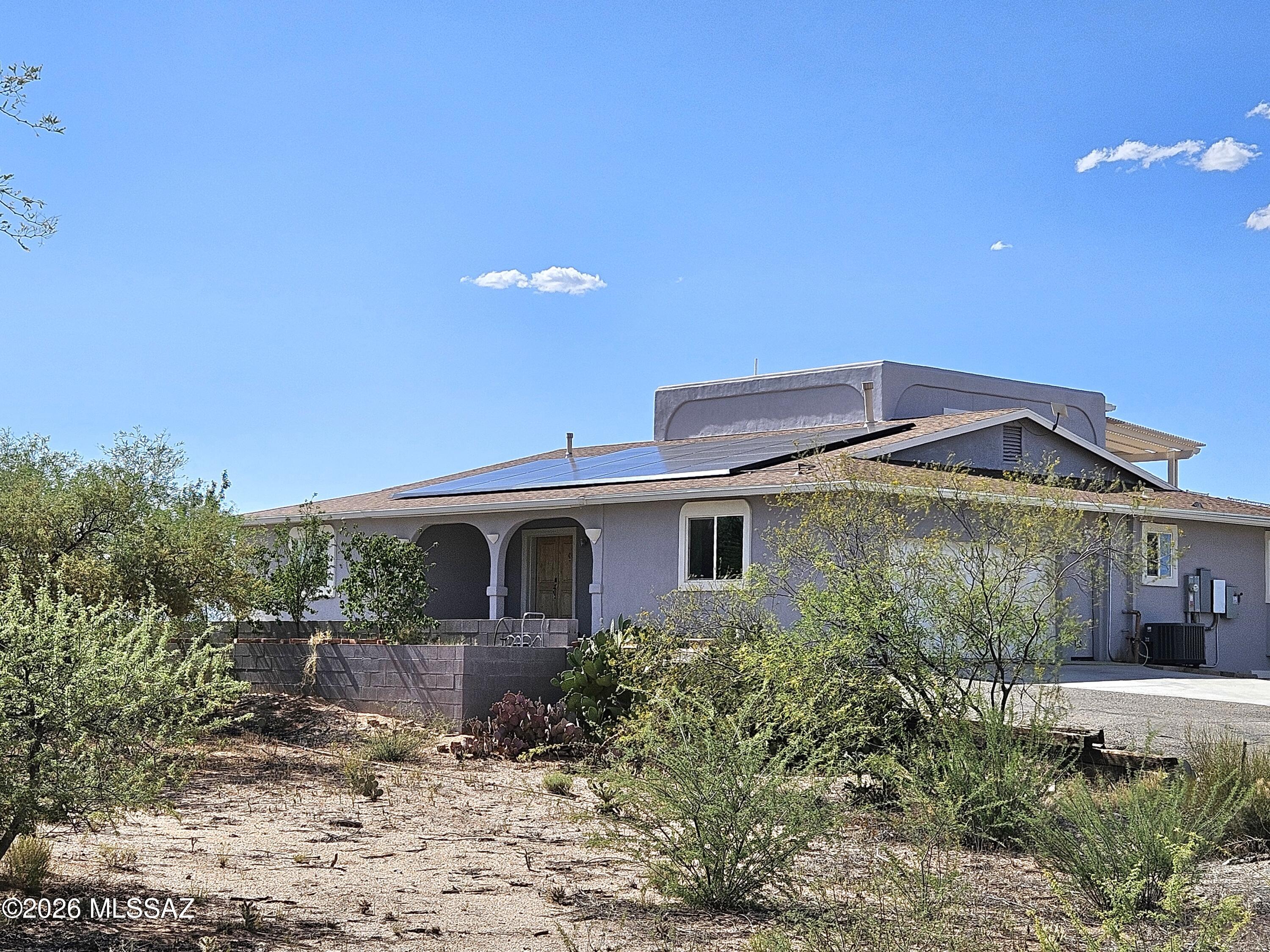 Views! Views! Views!  This property sits high above Benson.  Minutes away from shopping, dining & schools.  Close access to Hwy 90 or I-10 for easy commuting.   This multi-level, insulated concrete, updated home was built in 1994 & has so much to offer!  5 bedrooms, 3.5 baths, natural gas fireplace, a jetted jacuzzi tub, 2 car garage, 2 covered balconies, a covered patio & paved driveway. Beautiful wooden entry doors lead into the main level that has a formal family room w/ vaulted ceiling. The kitchen has granite counter tops, newer white cabinets, island w/separate sink, quality appliances & large bay windows in the breakfast nook. There is a full 2nd master suit w/french doors that open to a balcony to take in all the stunning views. The upper level also has it's own balcony w/2 bedrooms (without closets)   The Lower level has 2 bedrooms w/bar area & access to the covered porch.  The sale includes an additional adjoining lot giving a total of 36 acres! Fruit producing trees. Chicken coop. Fully fenced & cross fenced. Tesla owned solar system w/solar gates. Rain gutters & rain catch tanks for water harvesting. A reverse osmosis system & colored lighting system on the balconies also convey. This is truly a MUST SEE property!