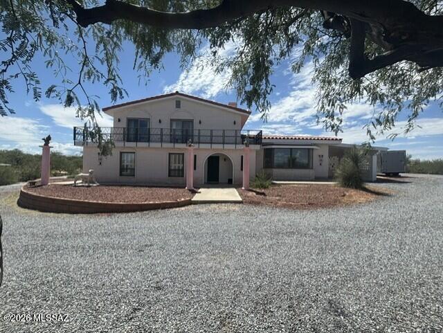 A rare blend of space, comfort, and sweeping desert beauty, this 13-acre Benson retreat delivers the privacy you crave with the upgrades you'll appreciate from day one. This two-story brick and masonry home has 3 bedrooms and 2 bathrooms with almost 3000 SF and is framed by panoramic views in every direction. Inside, you'll find warm character throughout, including two wood-burning fireplaces perfect for cozy evenings. The home features a remodeled bathroom, new hot water heater, and a new A/C system, giving you modern efficiency and charm.  The tile roof adds durability, while the property's private well plus city water offer flexibility and peace of mind. Step outside to enjoy a private patio ideal for entertaining, morning coffee, or quiet desert sunsets. Upstairs, the primary bedroom boasts one of the fireplaces and a balcony creating a serene vantage point over your expansive acreage.  A fenced yard provides a secure outdoor living, and the full 13 acres offer endless possibilities, subdivide the land, add another home on the property or simply have room to breathe. This is Benson living at its best: space, views, upgrades, and the freedom to make the land your own.