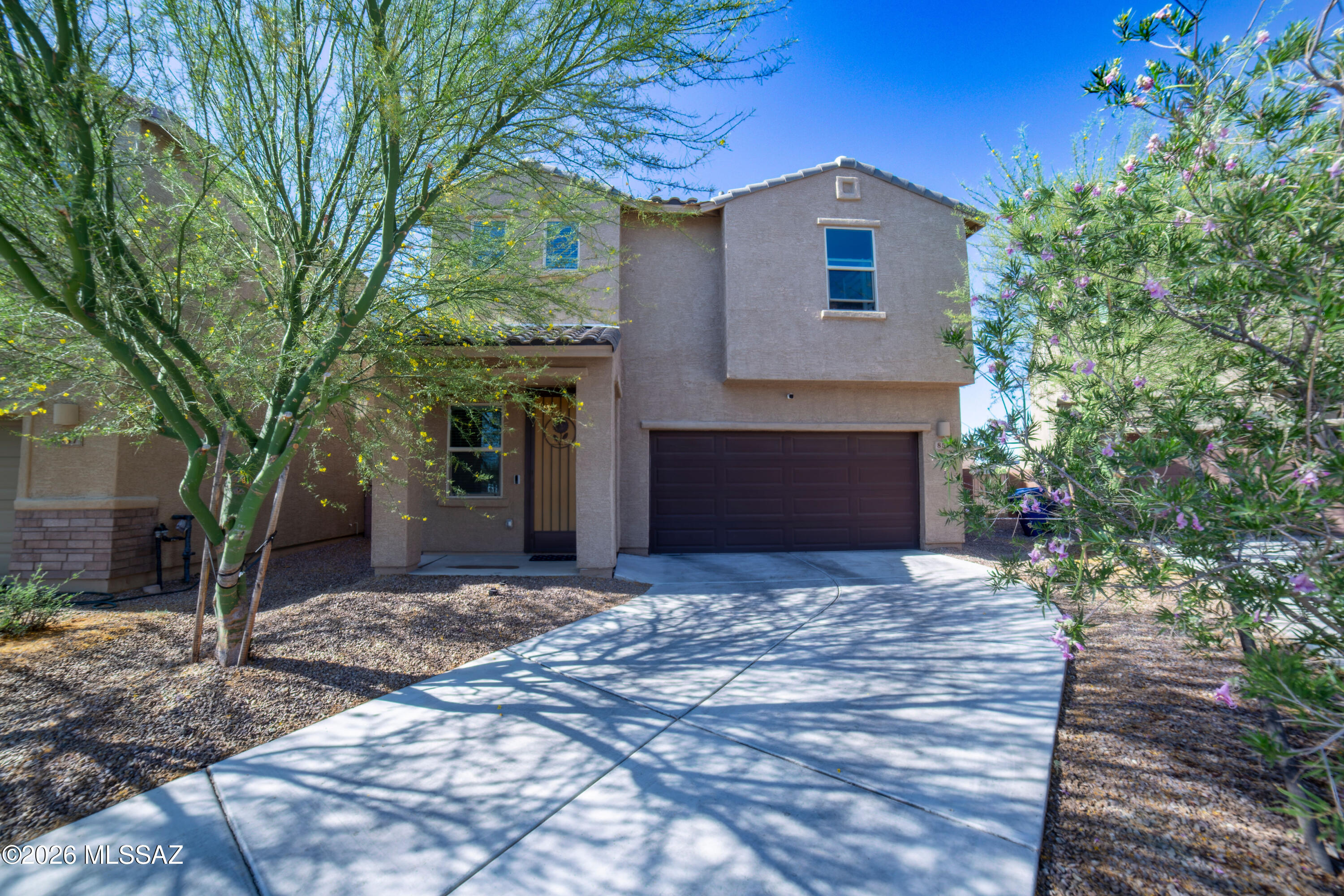 From the moment you arrive, the home offers a warm first impression with mature desert landscaping, shade trees, and a welcoming entry that leads you inside. Step through the front door and you're greeted by a bright, comfortable layout with wood-look tile flooring, soft neutral tones, and an easy flow that pulls you naturally toward the heart of the home. The kitchen, dining, and living areas all connect in one open space, making it feel effortless to cook dinner while staying part of the conversation, host friends around the island, or settle into a quiet evening at home. Rich cabinetry, granite countertops, stainless steel appliances, and modern lighting give the space a polished feel while still keeping it warm and livable. Upstairs, the home continues to offer room to spread out. A spacious loft creates the perfect flex space for movie nights, a play area, homework zone, home office, or second living room. The primary suite feels tucked away and comfortable, with generous natural light and an en-suite bathroom designed for everyday ease. The additional bedrooms and upstairs bathroom provide space for family, guests, or whatever season of life needs room next.

Even the practical spaces have been thoughtfully designed, including a dedicated laundry room with cabinetry and a utility sink. And out back, the yard is ready to be enjoyed from day one. Artificial turf, an extended paver patio, decorative rock, and string lights create a low-maintenance outdoor space that feels perfect for barbecues, playtime, evening conversations, or simply enjoying the Arizona sky.

With solar panels, a two-car garage, flexible living spaces, and a location near neighborhood amenities, schools, parks, shopping, dining, and I-19, this home offers comfort, convenience, and a backyard made for everyday memories.

Welcome Home!!