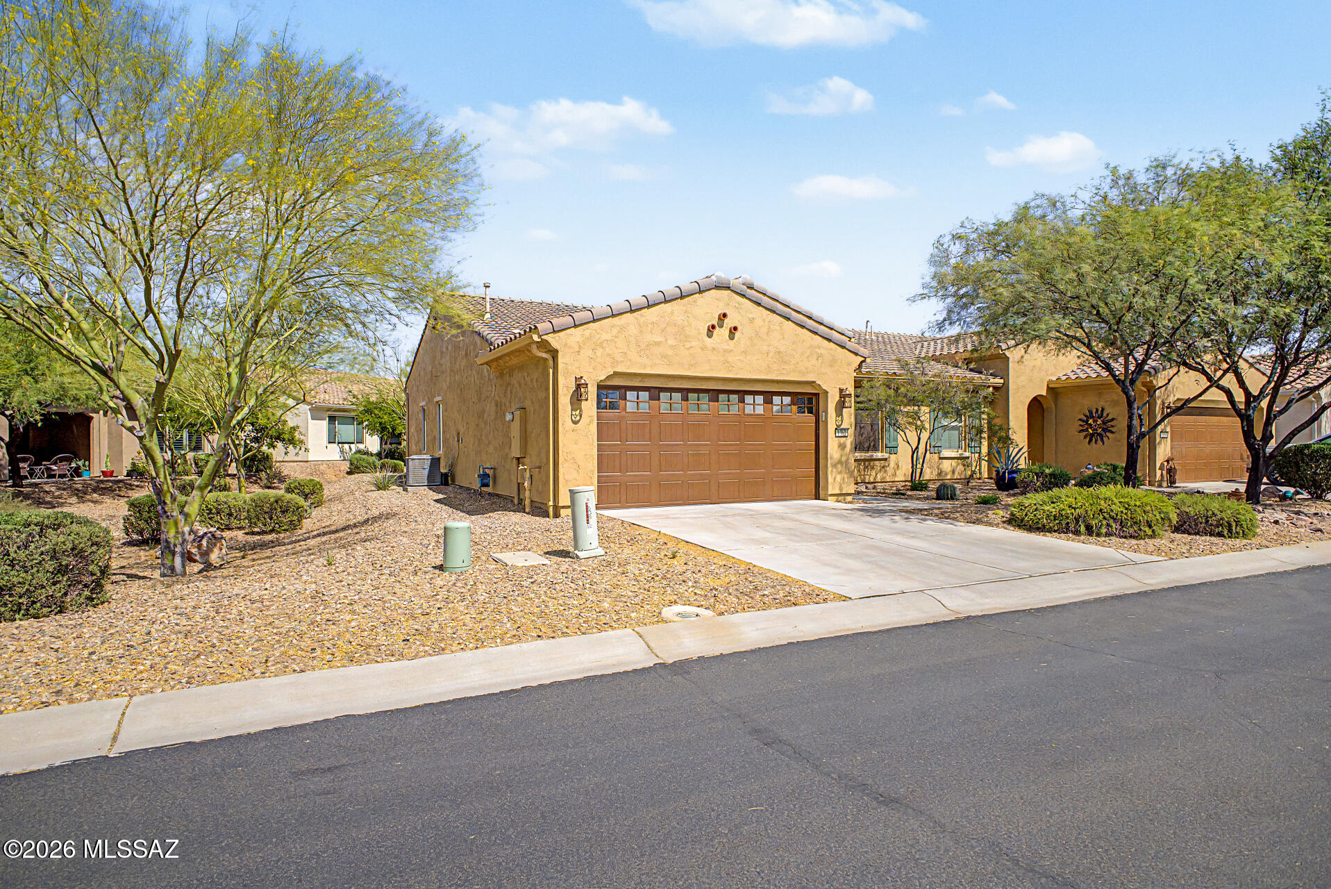 Private end-unit Sagebrush Villa with side & back open space and a large extended paved patio. This home is in a quiet, completed neighborhood and loaded with upgrades: ceramic tile throughout (no carpet) for easy cleaning, wood blinds, Hunter Douglas patio Vertiglide, in wall fan controls and granite kitchen with stainless appliances. Open concept great room with lots of windows. You'll love the beautiful two-tone kitchen cabinets and big island. Thoughtful details include bedroom solar screens, comfort-height toilets, hot water recirculating pump, and primary bath with rainfall shower. Pristine garage with epoxy floors, Closet Trends cabinets, and a workspace/bench. Stylish front entry gate with big trees and open views.
Neutral palette, immaculate, and truly move-in ready.