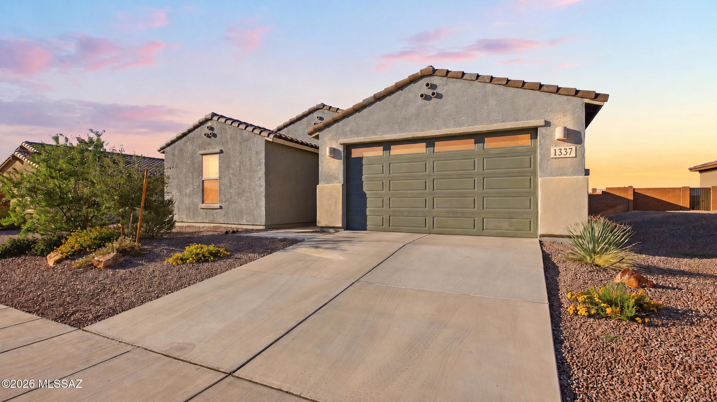 Nearly new, but already enhanced and ready to enjoy! Built in 2024, this Madera Highlands home features an open-concept floor plan, warm wood-look tile, marble-look granite countertops, white cabinetry, updated interior paint, and decorative flake epoxy flooring in the garage. The home offers three bedrooms plus a spacious flex room with a closet and French doors--ideal as a potential fourth bedroom, exercise room, office, or den. The private primary suite is separated from the secondary bedrooms and includes dual sinks and a large walk-in closet. The completed backyard features pavers, a fully enclosed rear wall for added privacy, and a Signature Spas hot tub with three river jets for exercise or relaxation. Enjoy swimming, parks, sports courts, and walking trails within Madera Canyon.