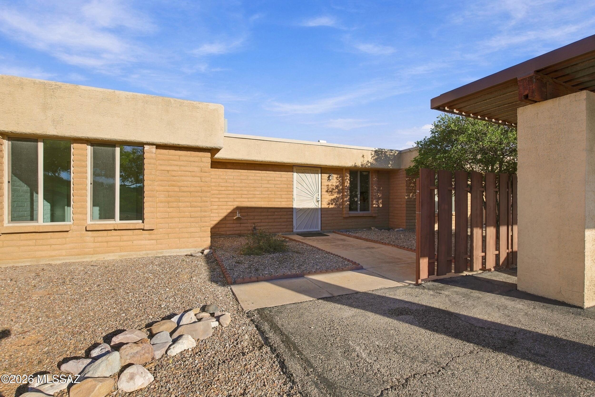 Beautifully remodeled 2-bedroom, 1-bath townhouse on Tucson's desirable east side! Thoughtfully updated throughout, this move-in-ready home features brand-new flooring, windows, and appliances, creating a fresh, modern feel. Enjoy peace of mind with a new roof and new water heater, adding both value and efficiency. The inviting layout offers comfortable living spaces, while the covered patio provides the perfect spot to relax and unwind. Enjoy access to the community pool, ideal for cooling off on warm Arizona days. Conveniently located near shopping, dining, and everyday amenities, this turnkey townhouse is the perfect blend of style, comfort, and low-maintenance living!