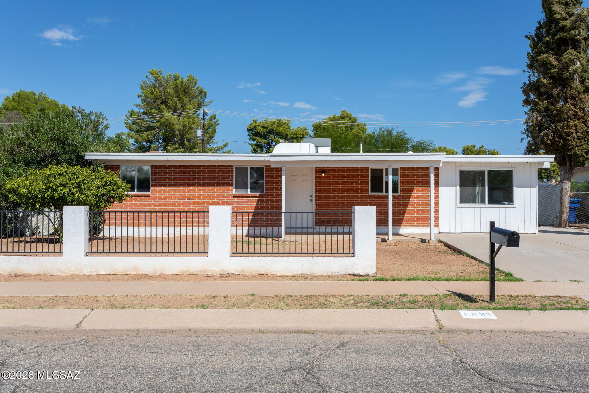 Charming updated ranch-style home in established east Tucson neighborhood! This 4 bedroom, 2 bathroom home offers 1,303 sq ft of functional living space with a versatile floor plan and bonus room. Interior features include ceramic tile flooring throughout, central A/C, and a bright kitchen equipped with stainless steel appliances.  Enjoy low-maintenance landscaping in both front and rear yards with mature trees, covered patio space, and fully fenced backyard. Situated on a spacious lot with no HOA. Convenient location close to schools, parks, shopping, dining and easy access to Davis-Monthan Air Force Base.  Owner financing available with as little as 10% down. major roadways. Move-in ready opportunity ideal for owner-occupants or investors alike!