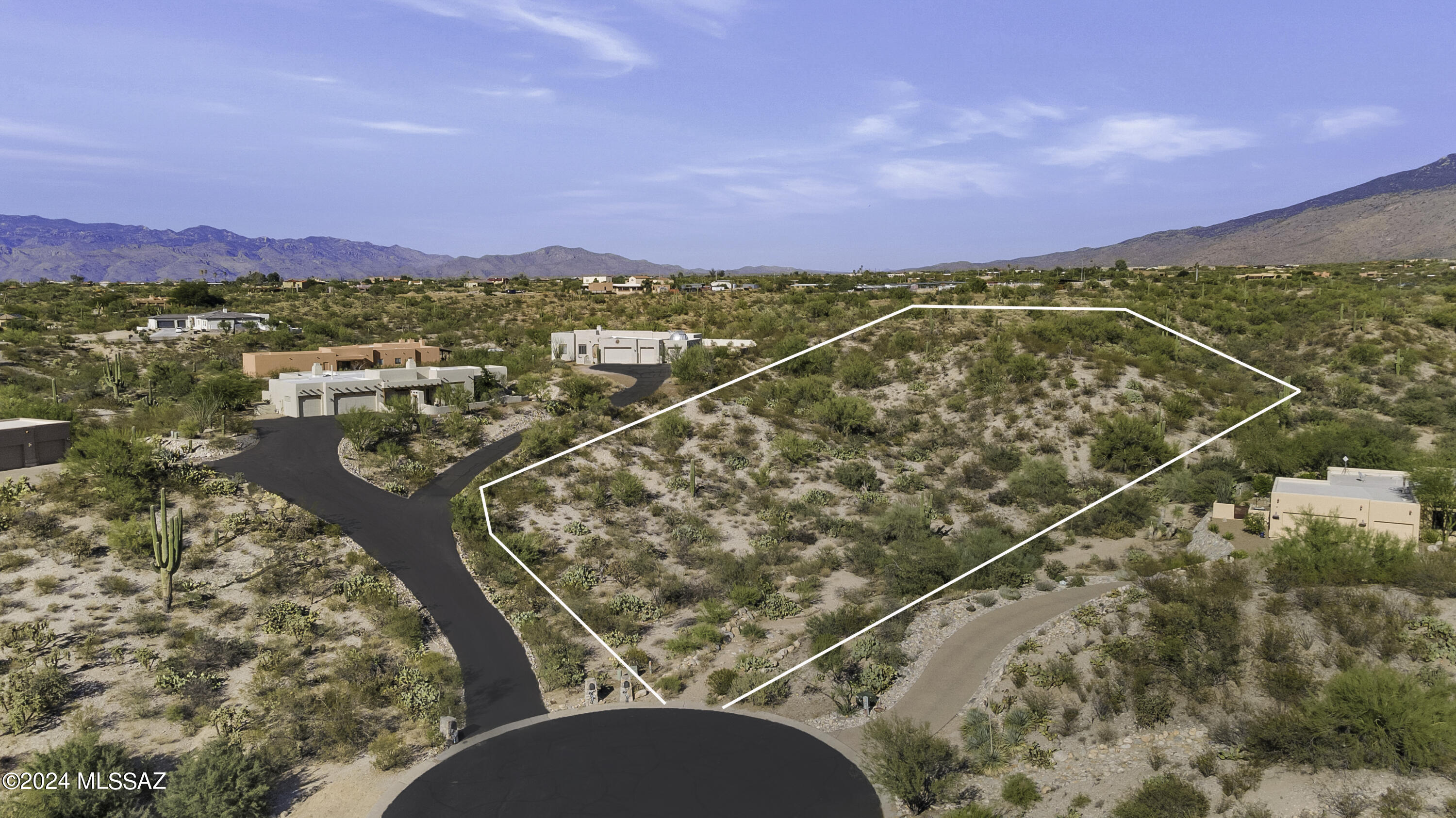Elevated 1.65-acre homesite at the end of a cul-de-sac in a gated enclave of custom homes. Enjoy sensational mountain views & true privacy without sacrificing convenience. Just three miles to Target, Walgreens, Fry's, Starbucks, Urgent Care, Dental Offices, & more. Two miles to connect to the Loop -Tucson's 133-mile connected bike trail- at the entrance to the Fantasy Island Mountain Bike Park. Three & a half miles to the entrance of Saguaro National Park East & Saguaro Corners restaurant. Just 7 minutes from Northwest Hospital. This homesite is the perfect place to build your dream home. Large building envelope. See documents tab for additonal information.